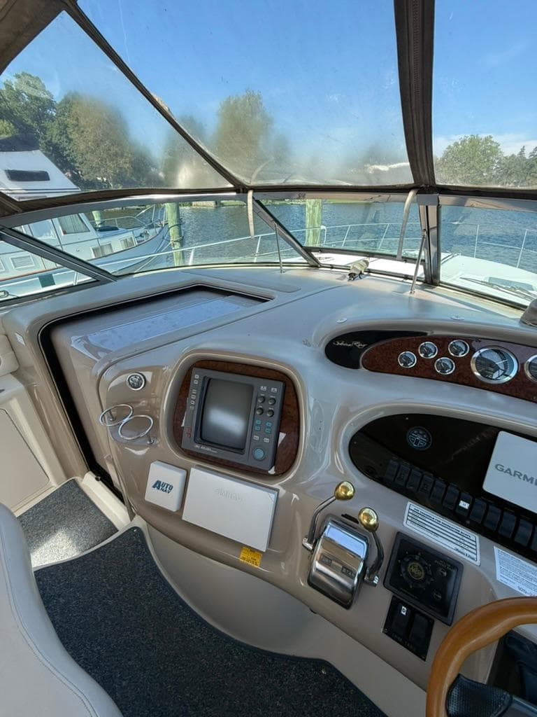 Helm of 2000 Sea Ray 380 Sundancer with navigation equipment and controls.
