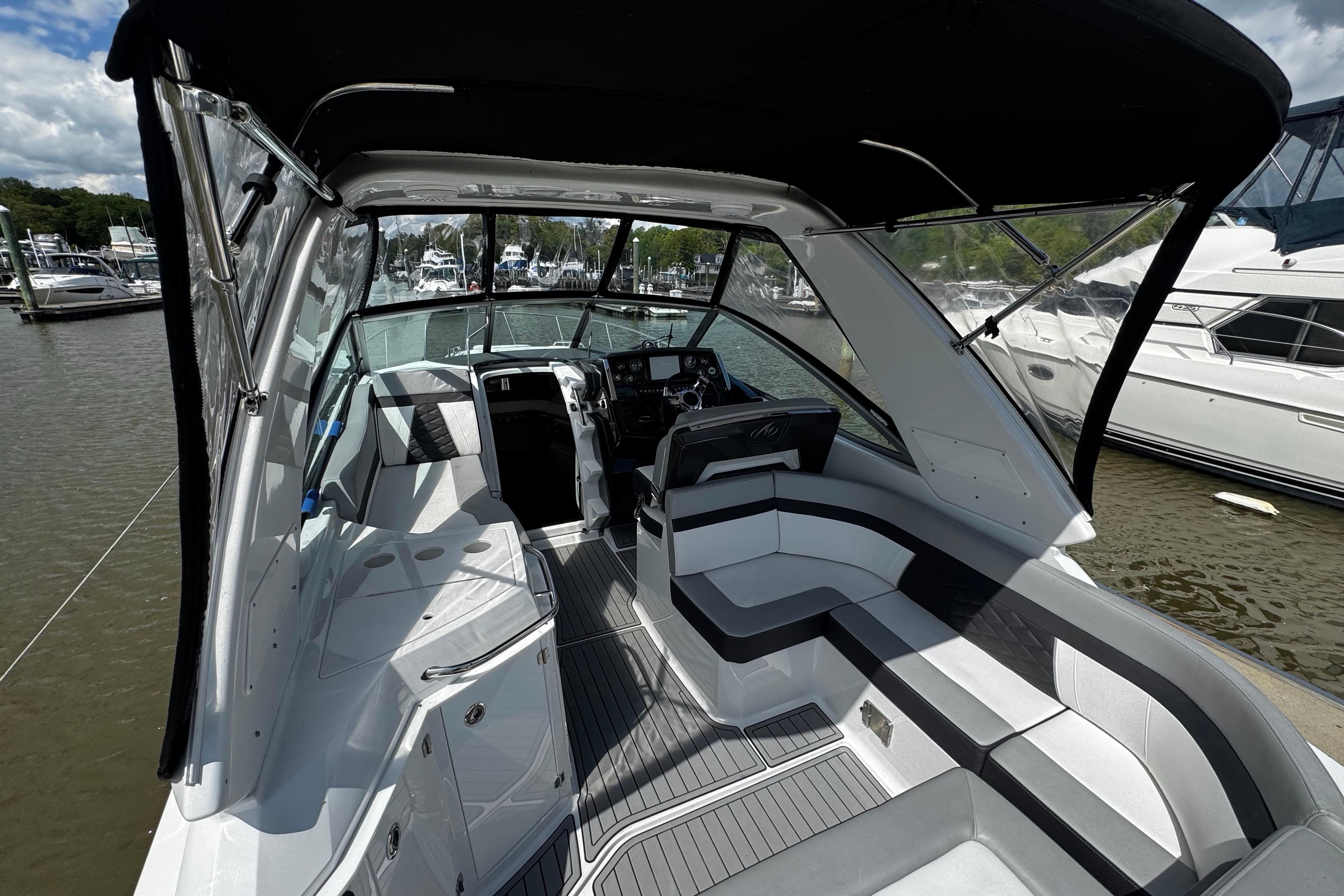 2022 Monterey 295 Sport Yacht interior with sleek seating and modern dashboard.