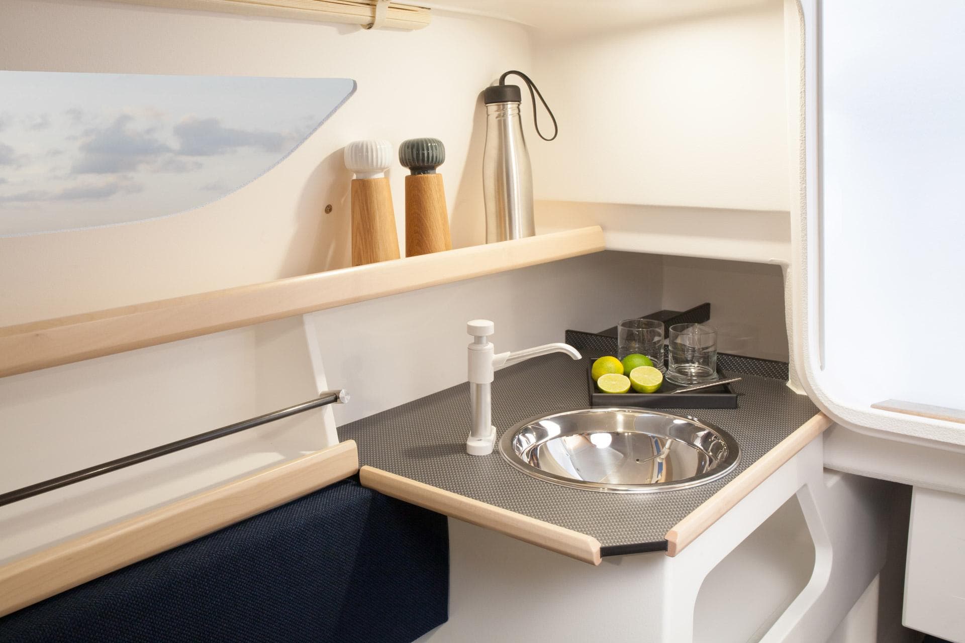 Compact kitchen area in 2026 Dragonfly 25 sailboat with sink and countertop accessories.