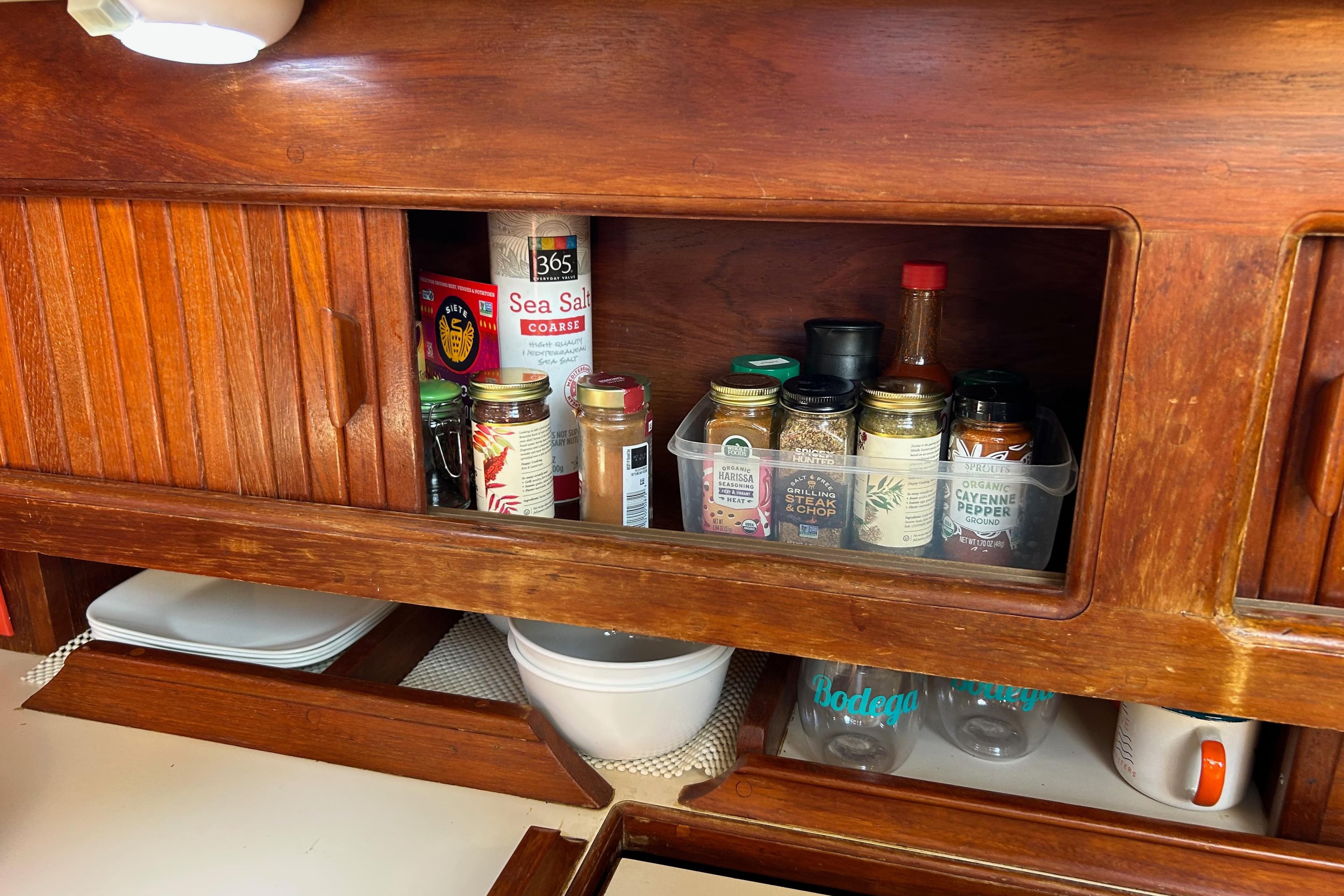 Wooden cabinet with spices and condiments on an Endeavour 37 sailboat, 1982 model.