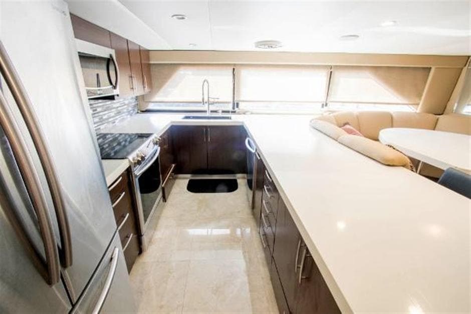 Luxurious kitchen in 1990 Broward Raised Pilothouse MY yacht with modern appliances.