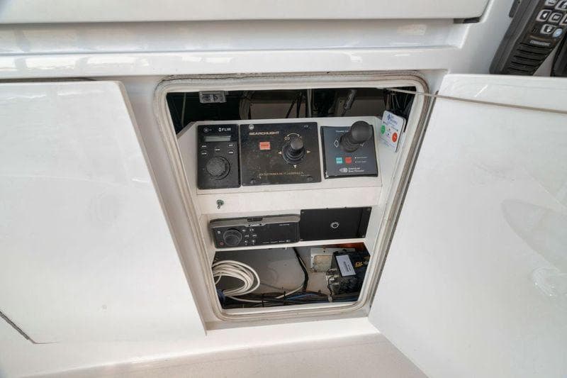 Control panel inside a 2009 Hatteras 60GT yacht, featuring various electronic components.