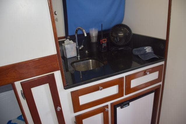 Galley with granite countertop, stainless sink
