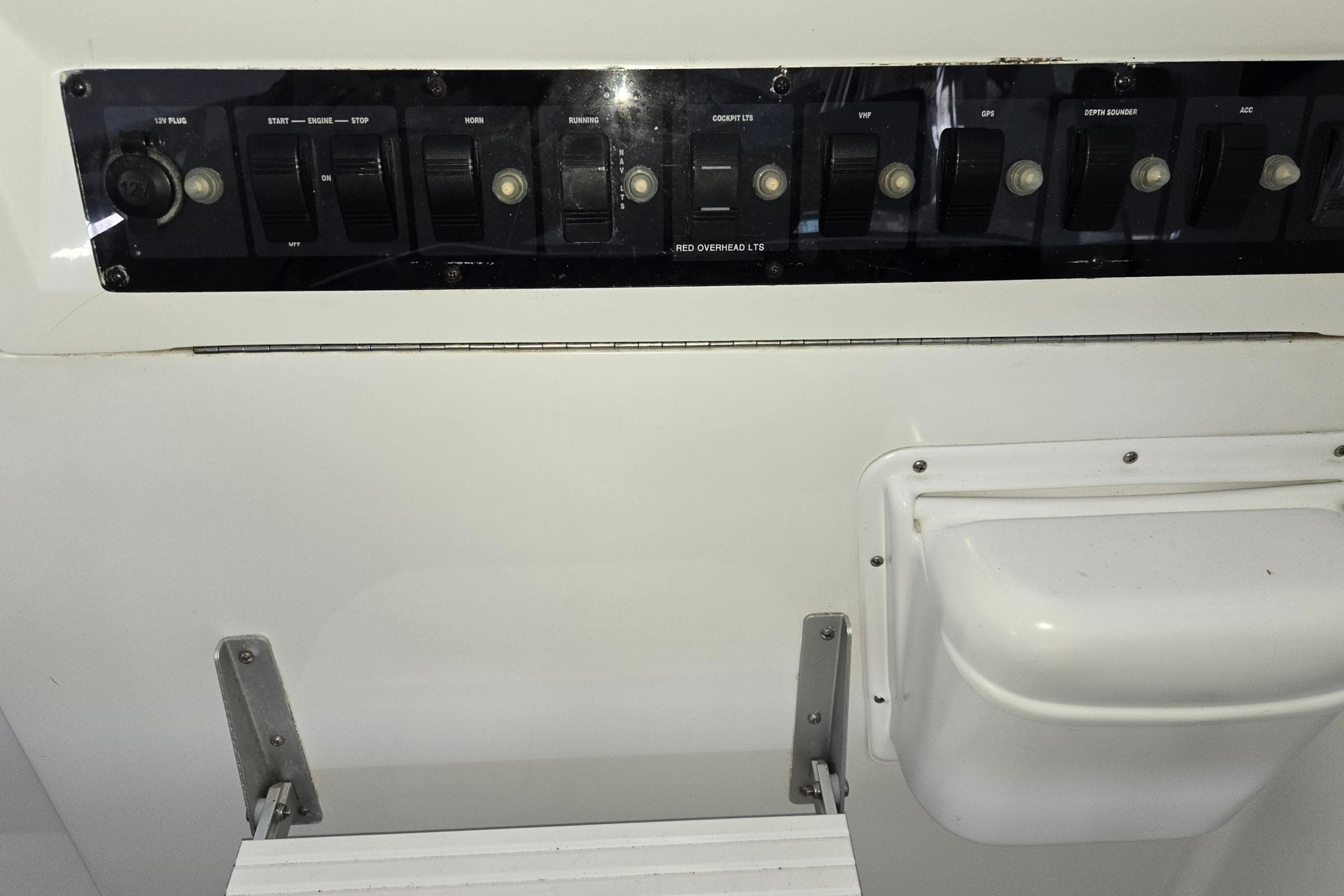 Control panel of a 1998 Mainship Pilot 30 boat with various switches.