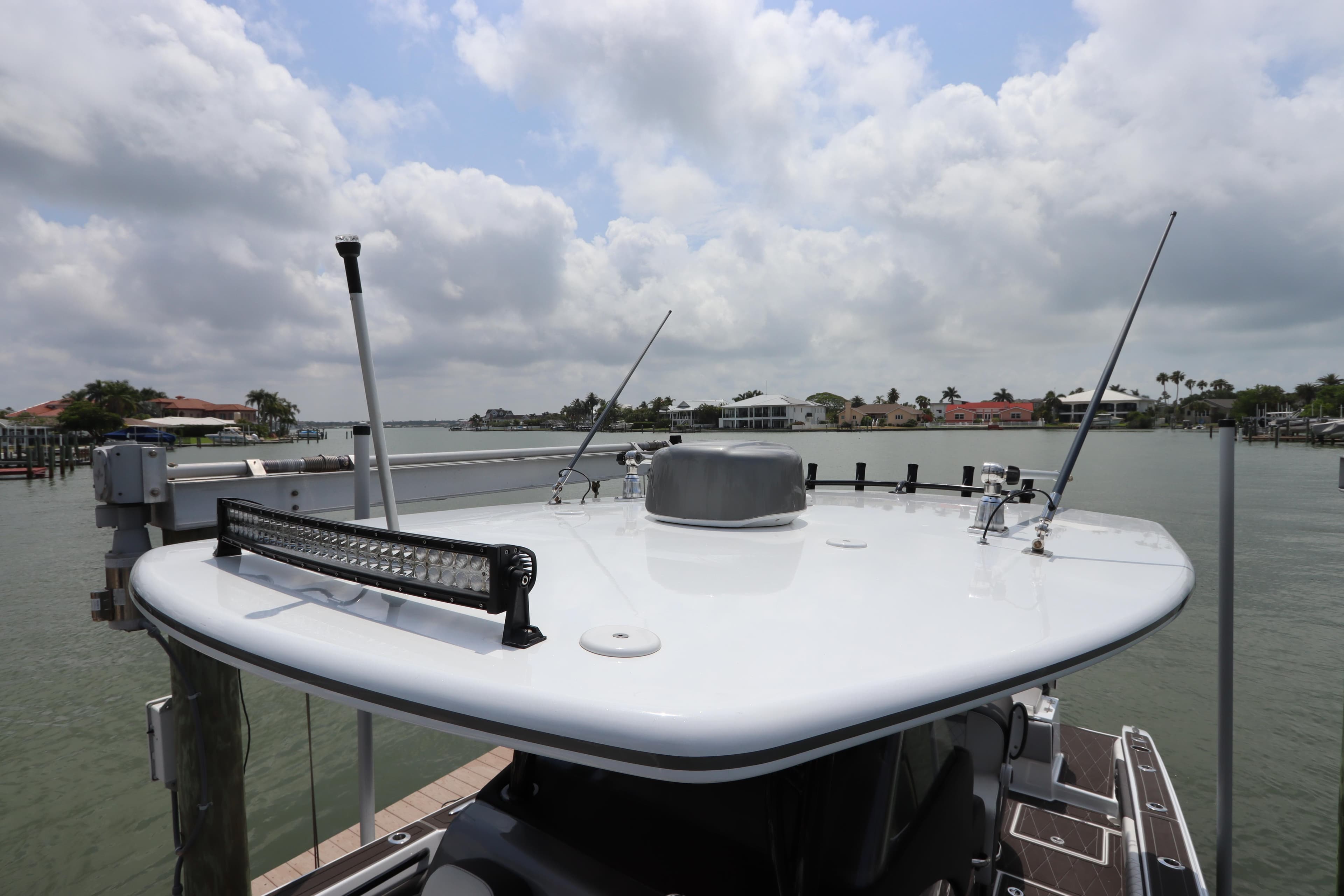 Statement 350 Open 2019 boat docked with a view of the water and cloudy sky.