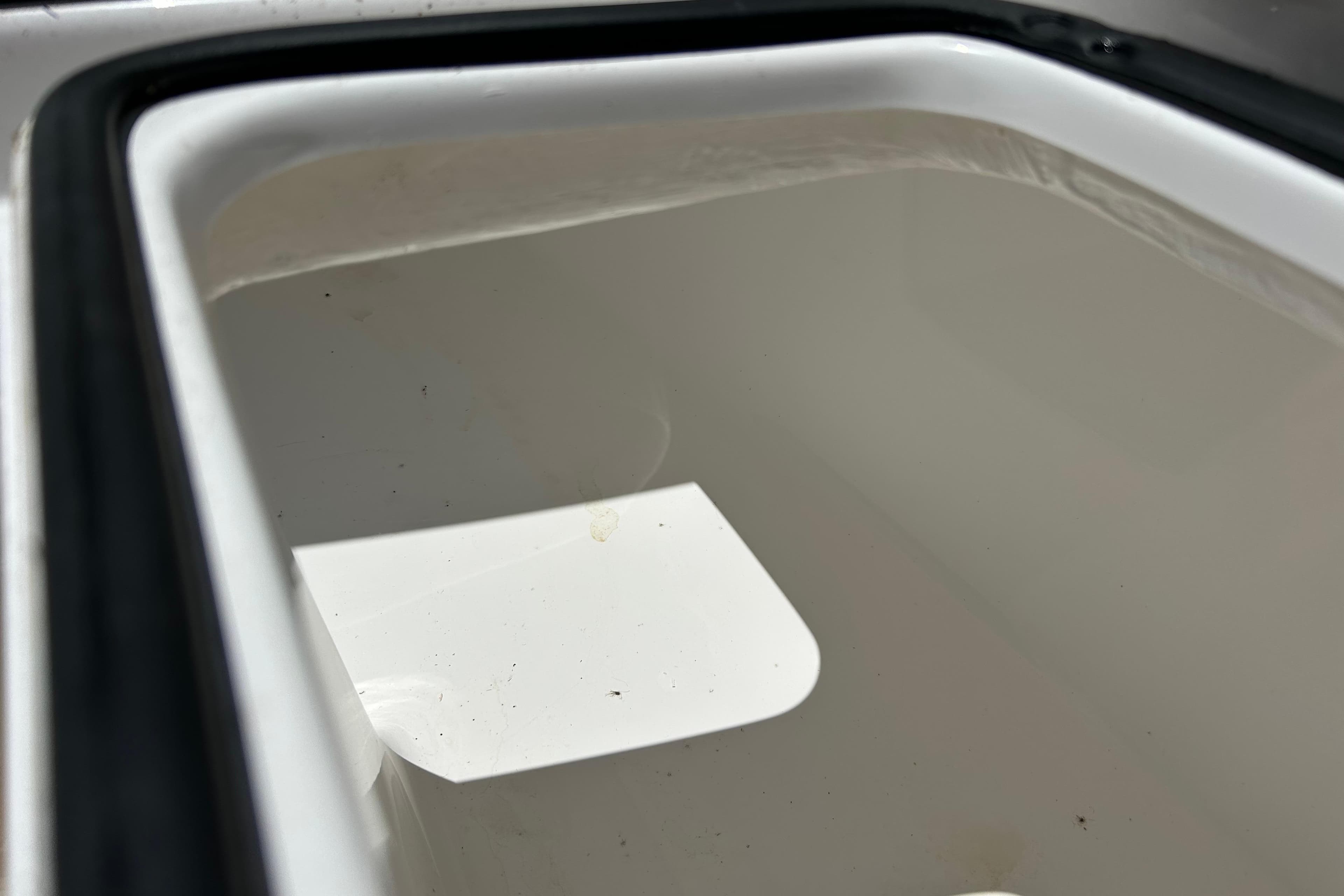 Storage compartment of 2025 Cape Horn 34 XS boat, featuring a clean, white interior.