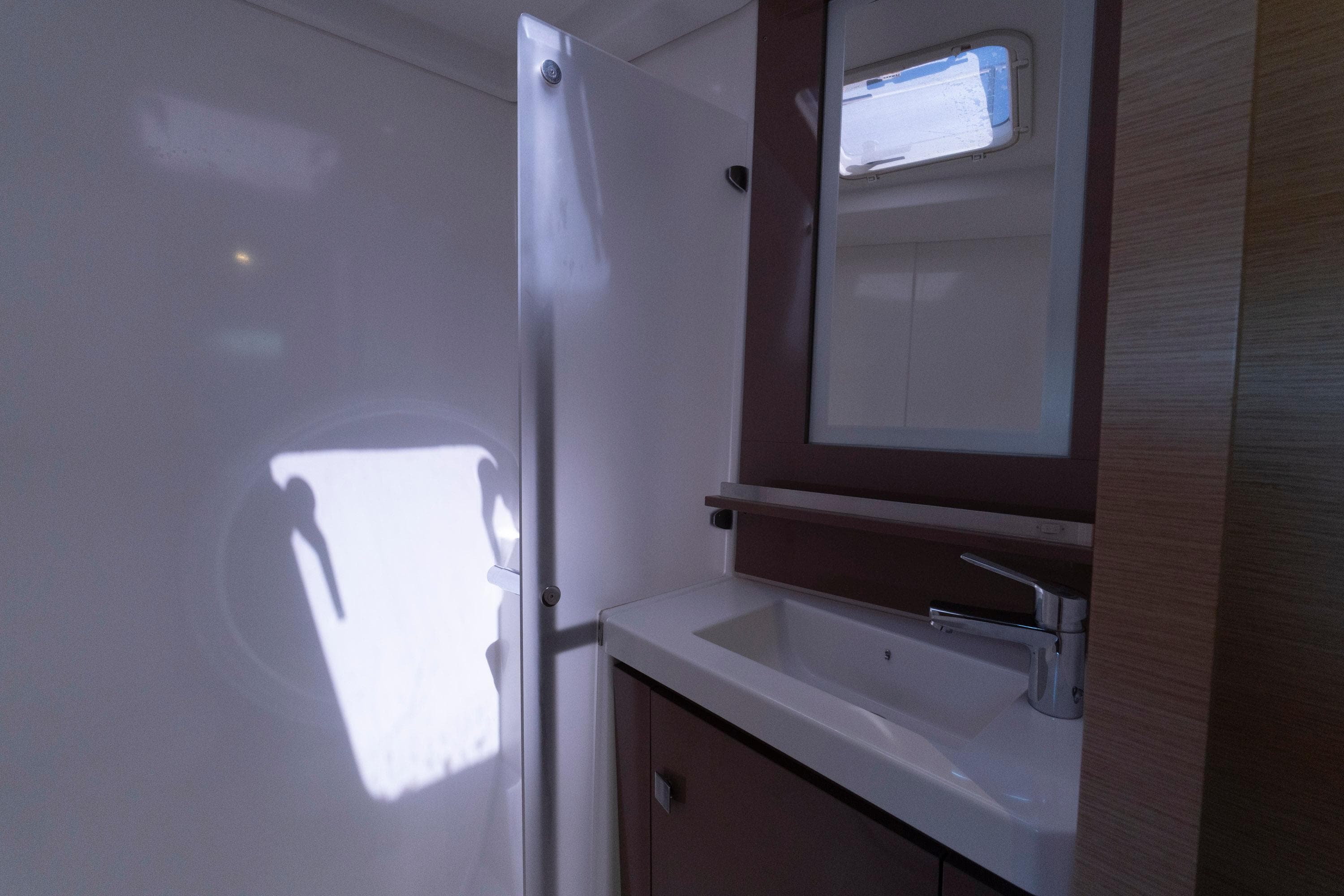 Bathroom interior of 2019 Fountaine Pajot MY 37 yacht, featuring sink and mirror.