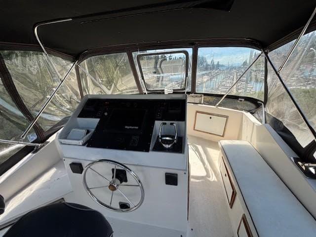 1988 Riviera Convertible boat interior with steering wheel and navigation controls.