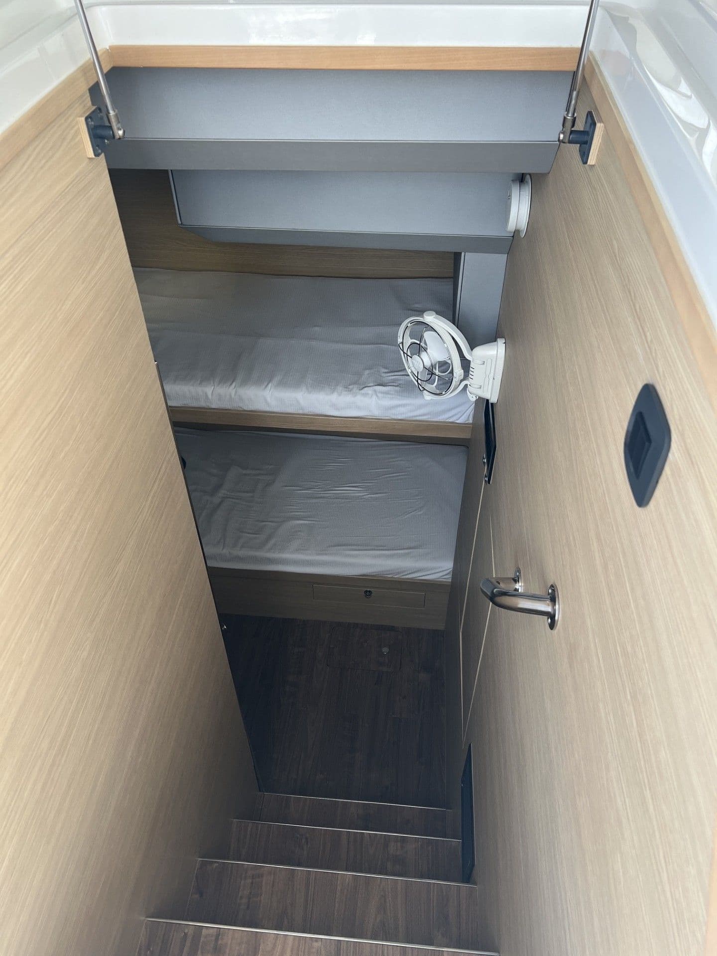 Interior of 2023 Aquila 54 Yacht with stairs and sleeping area.
