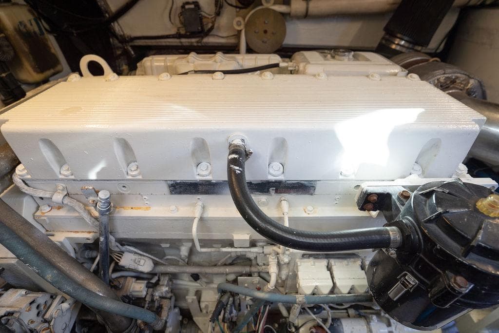 Engine compartment of a 2005 Tiara Yachts 4200 Open, showcasing mechanical components and hoses.