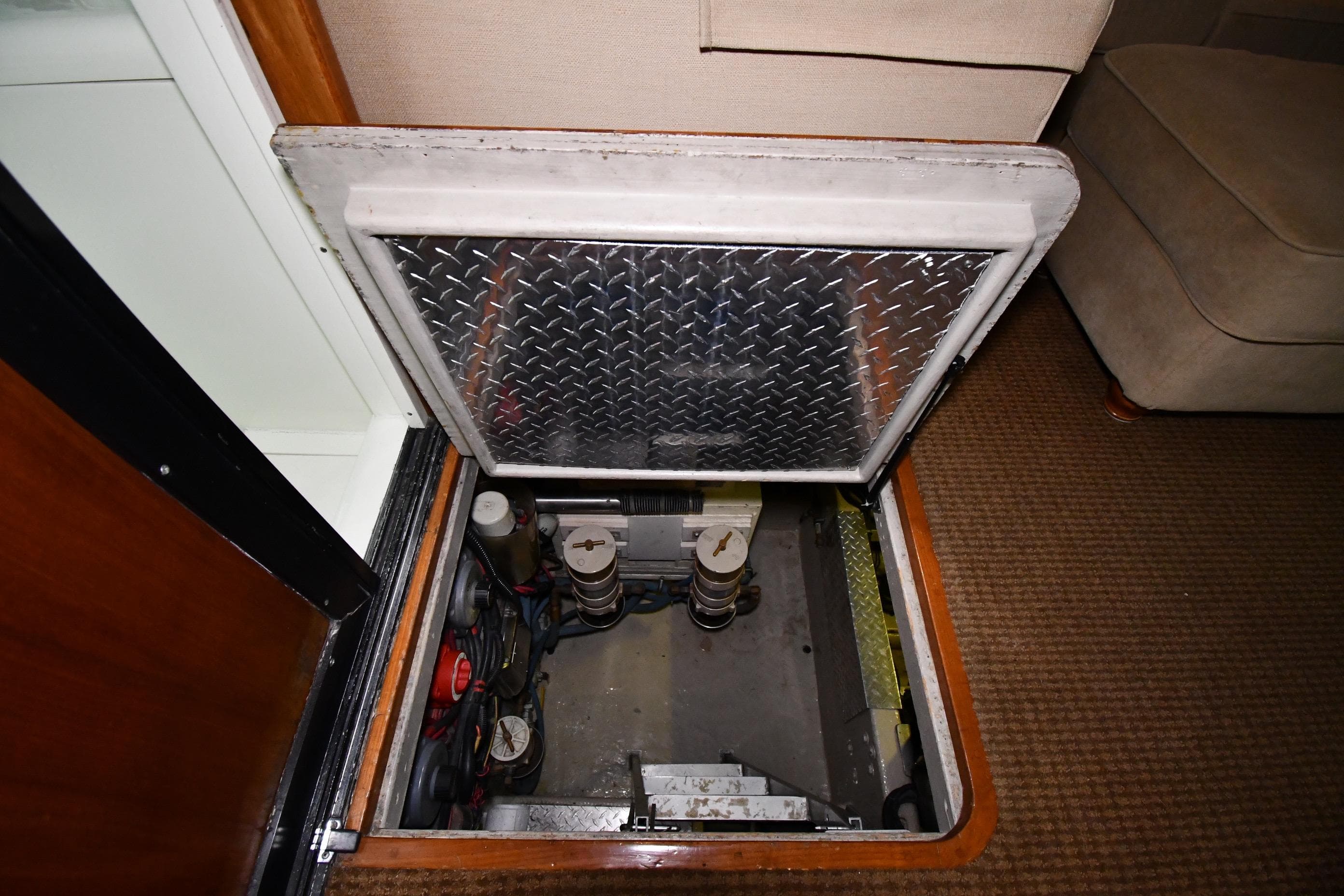 Engine compartment of a 1988 Viking 48 Convertible yacht with diamond plate hatch.