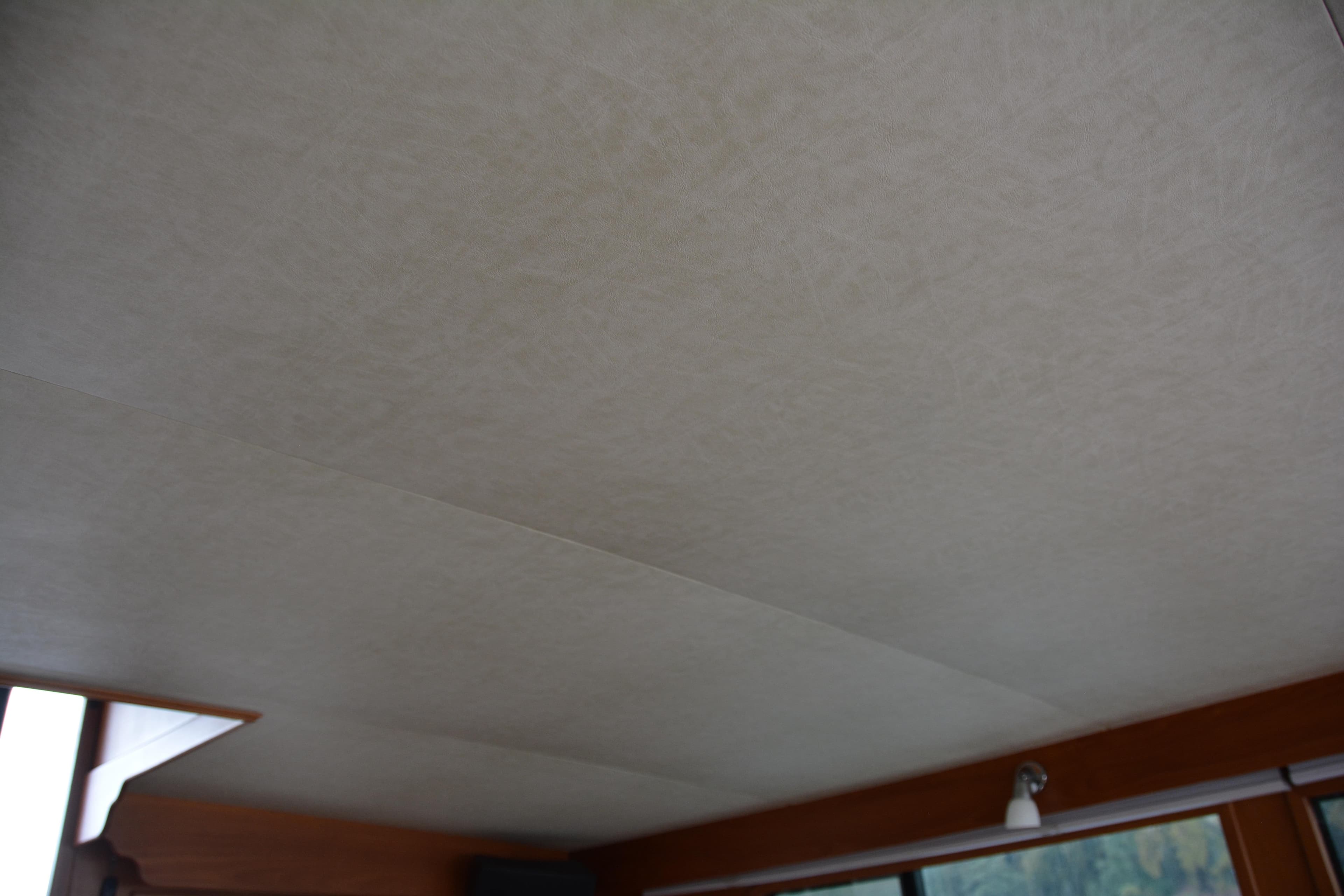 Interior ceiling of 1988 Camargue 48 Cockpit Motor Yacht, featuring light fixture and window.