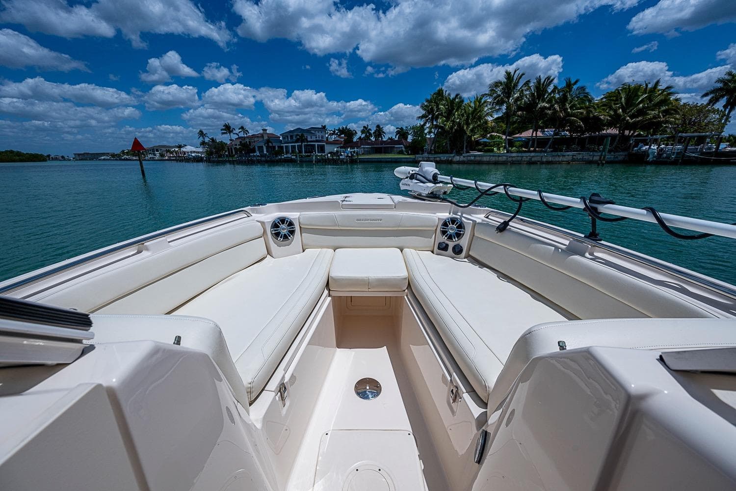 2022 Grady-White Freedom 285 boat interior with spacious seating, set against a scenic waterfront.