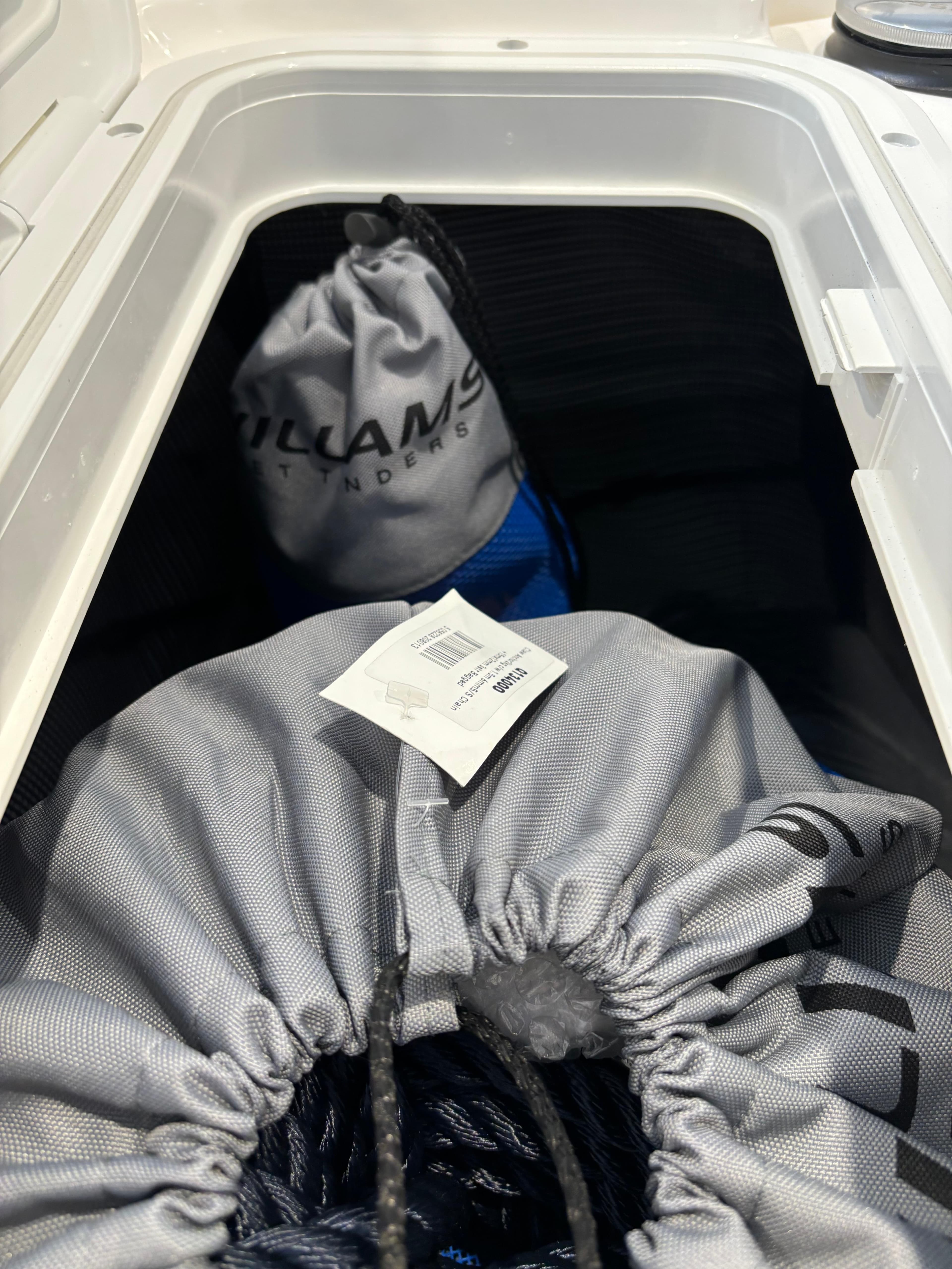 Storage compartment of 2024 Williams Jet Tenders DieselJet 445 with branded bags.