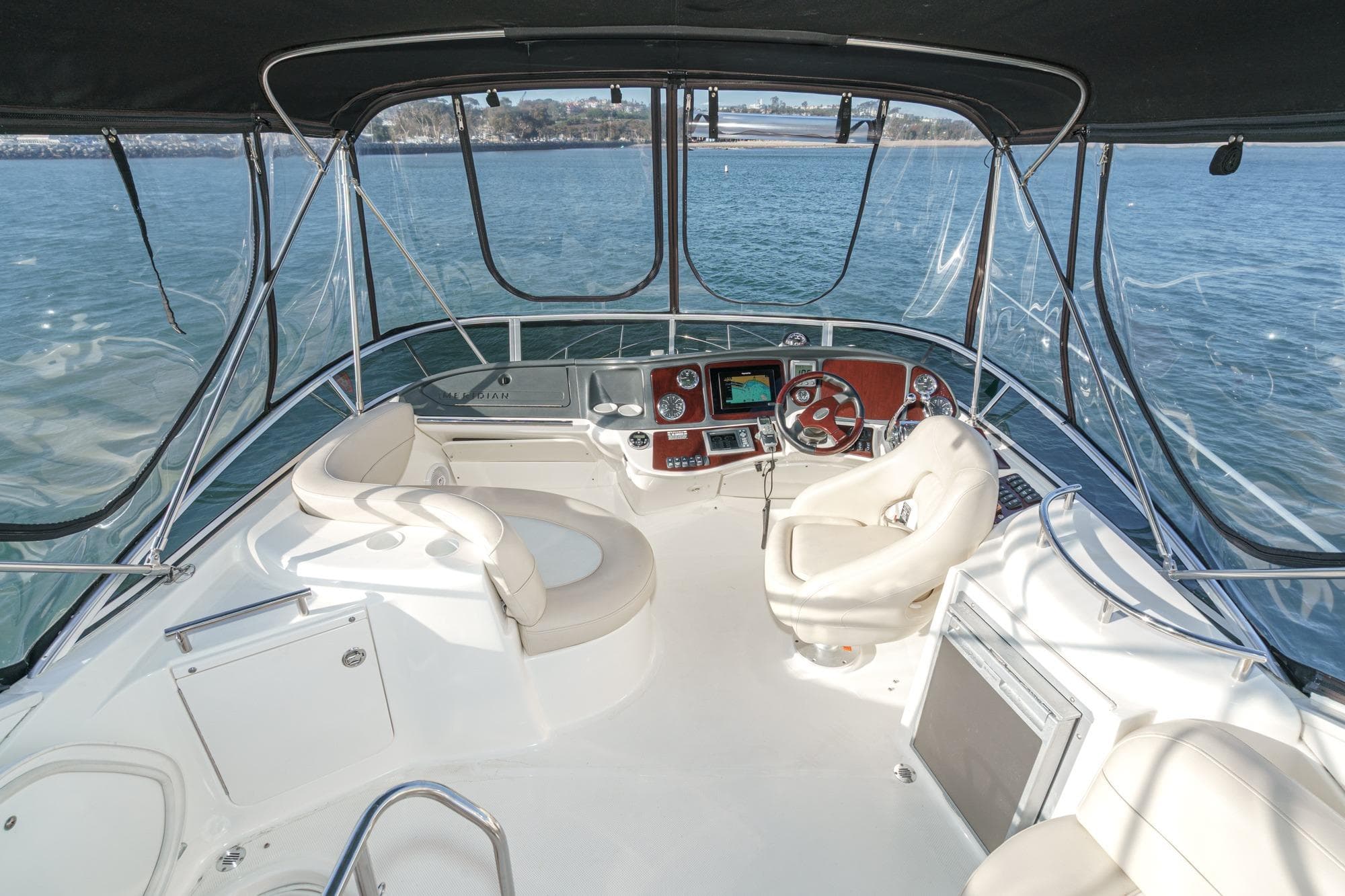 2011 Meridian 341 Sedan yacht helm with panoramic water views.