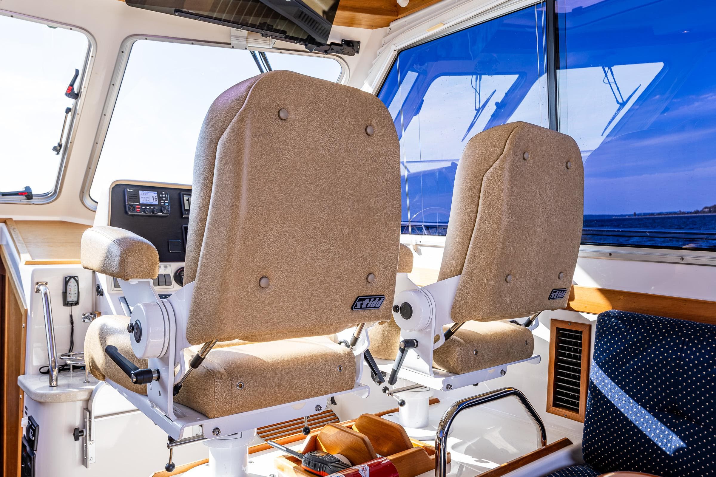 Interior of 2013 Back Cove 37 boat with two beige captain chairs.