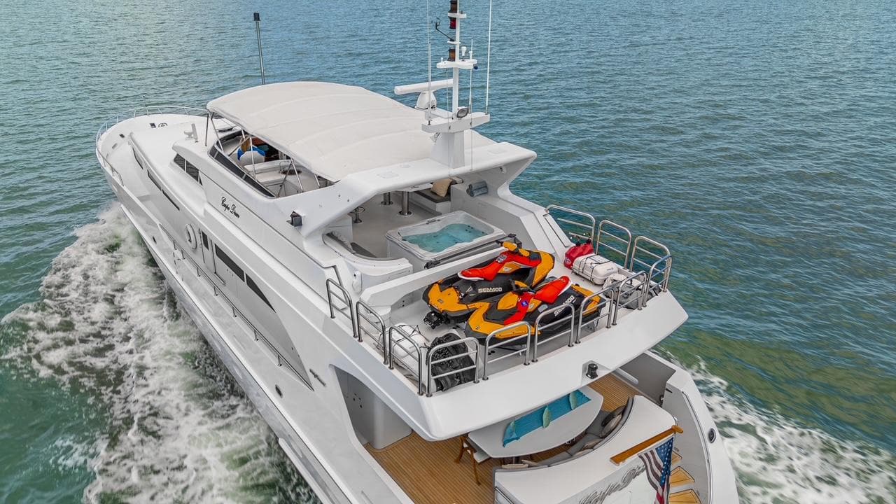 Luxurious 2001 Intermarine RPH 95 yacht cruising with jet skis on deck.