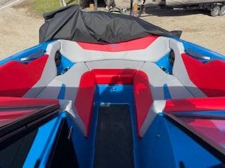 2024 MasterCraft NXT22 boat interior with red and gray seating.