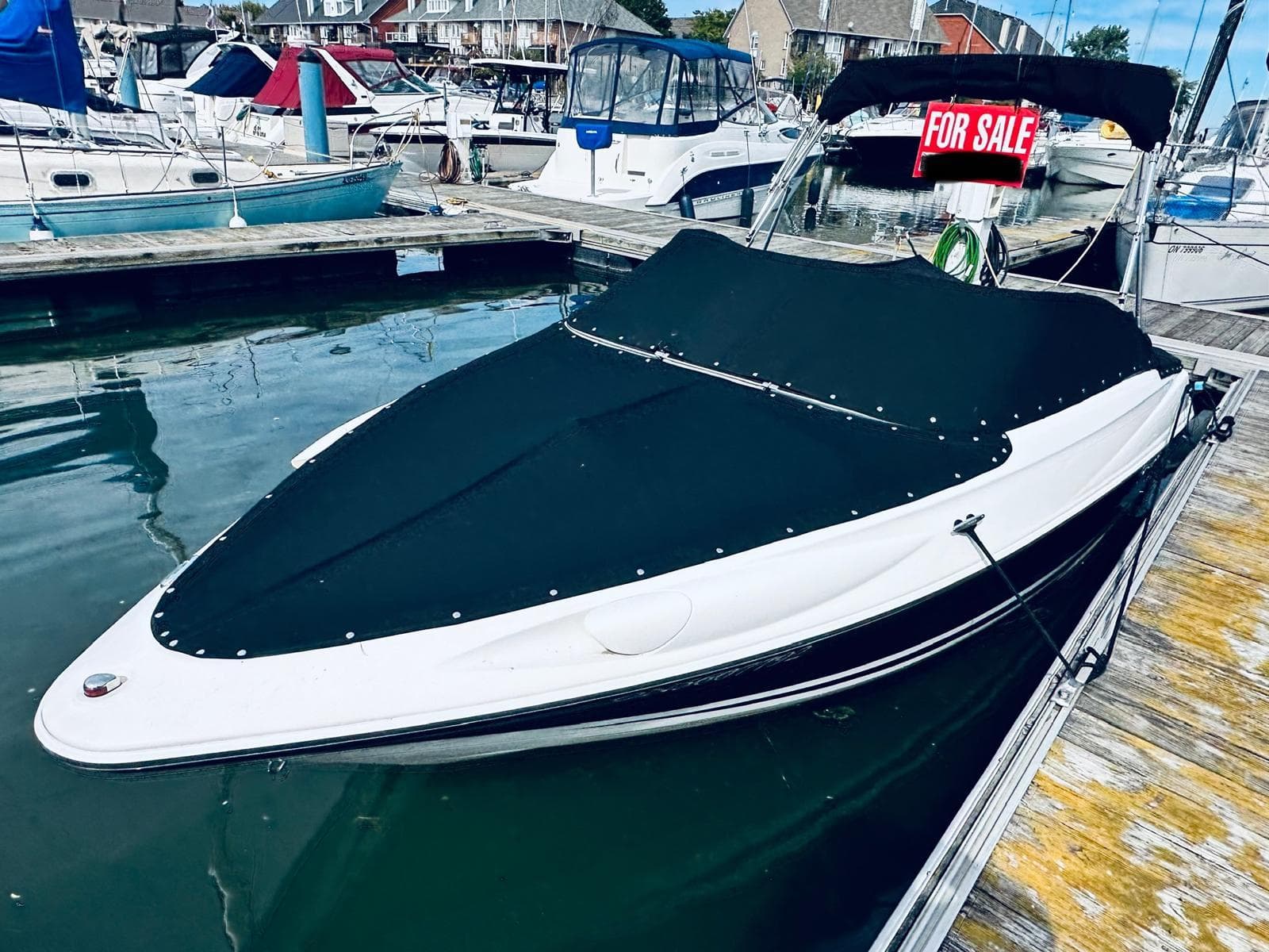 2016 Campion Allante 545i boat docked, covered, and for sale at a marina.
