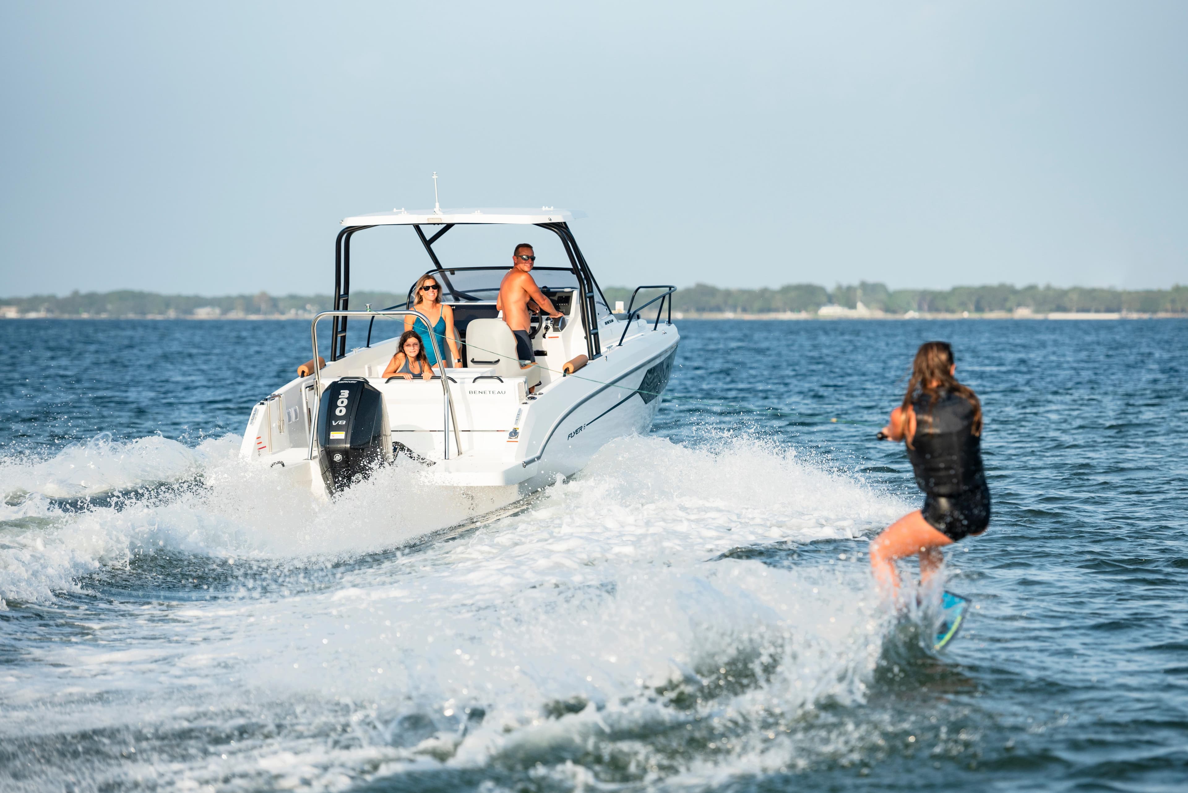 2025 Beneteau Flyer 8 SUNdeck towing a wakeboarder on open water.