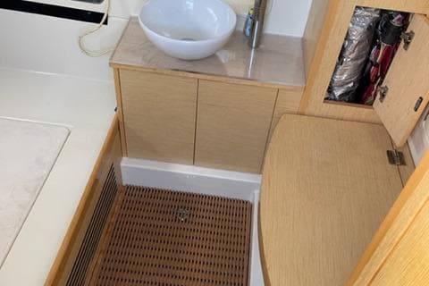 2017 Chris-Craft 35 Catalina bathroom with wooden cabinetry and modern sink.
