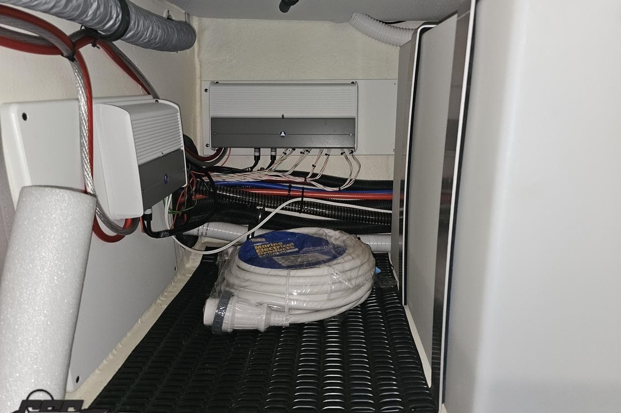 2020 Formula 330 Crossover Bowrider electrical compartment with wiring and coiled hose.