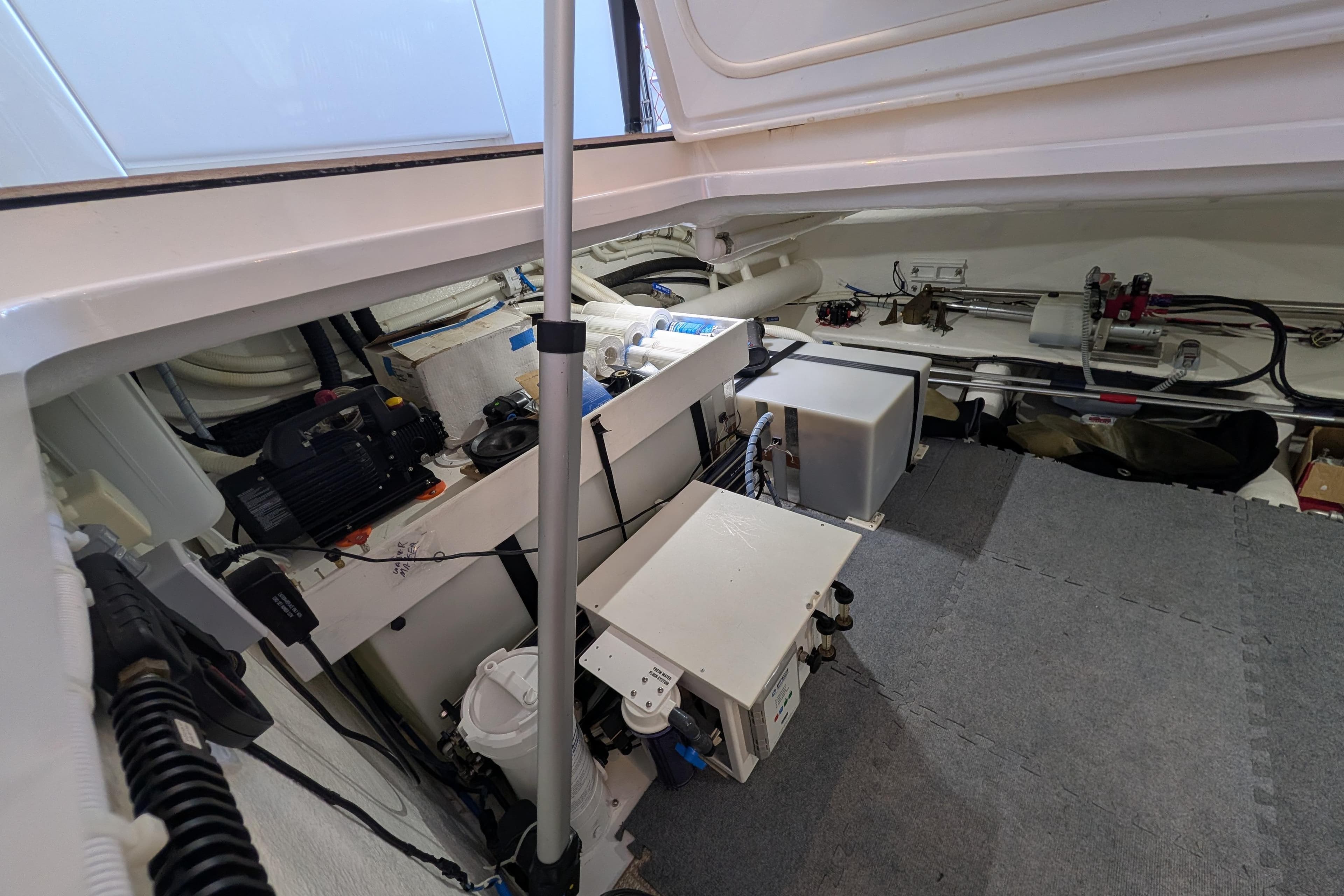 Engine room of 2015 Maritimo S58 yacht, showcasing mechanical components and equipment.