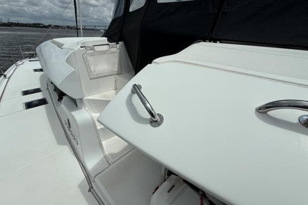 2023 Lagoon 46 yacht deck with sleek white design and stainless steel handles.