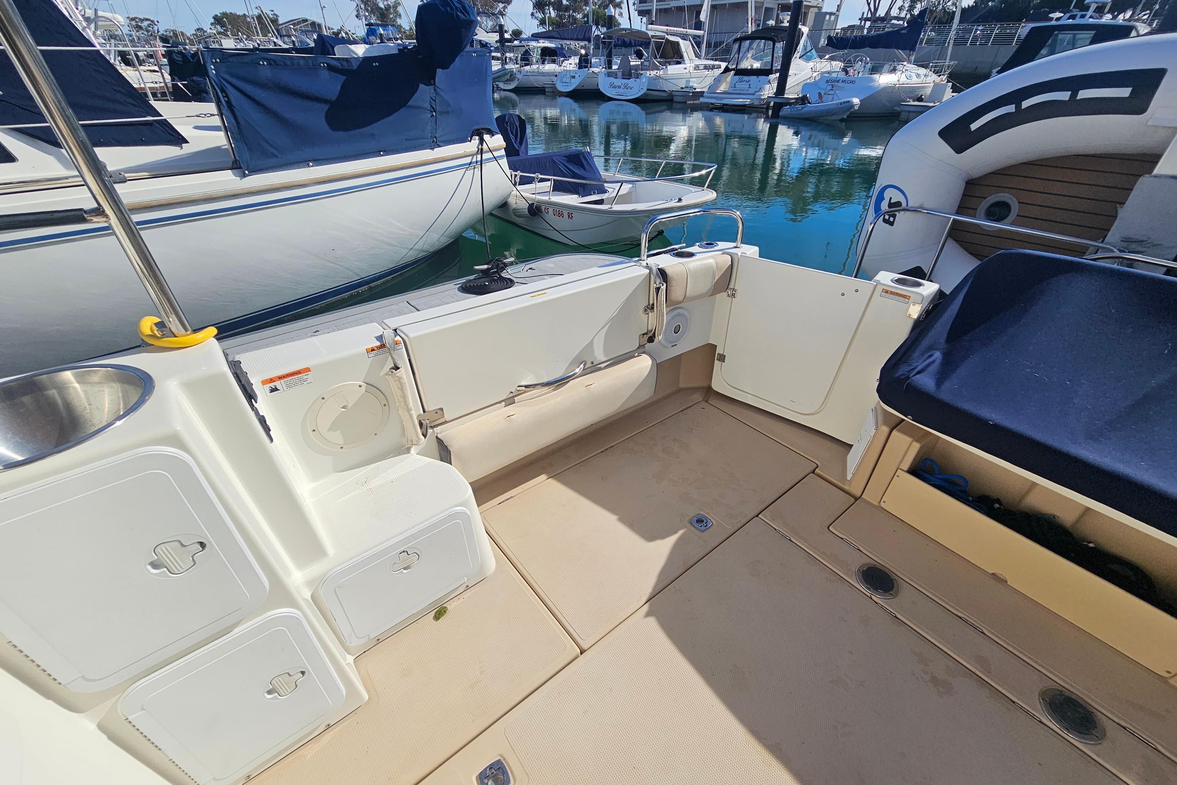 2015 Cutwater 30 Command Bridge boat interior, featuring deck and storage compartments at marina.