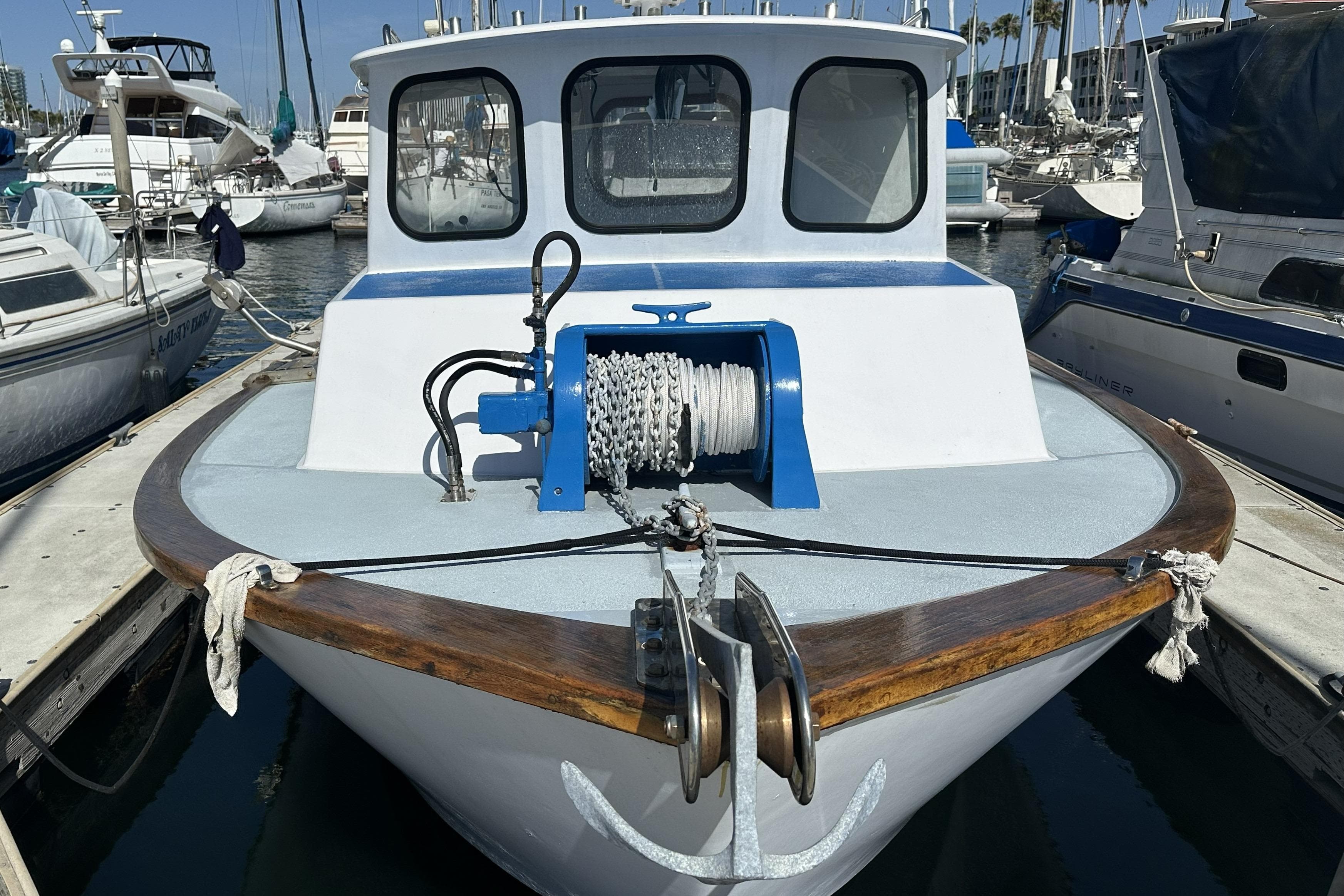 Front view of a 1990 Seeway 31 boat docked in a marina.