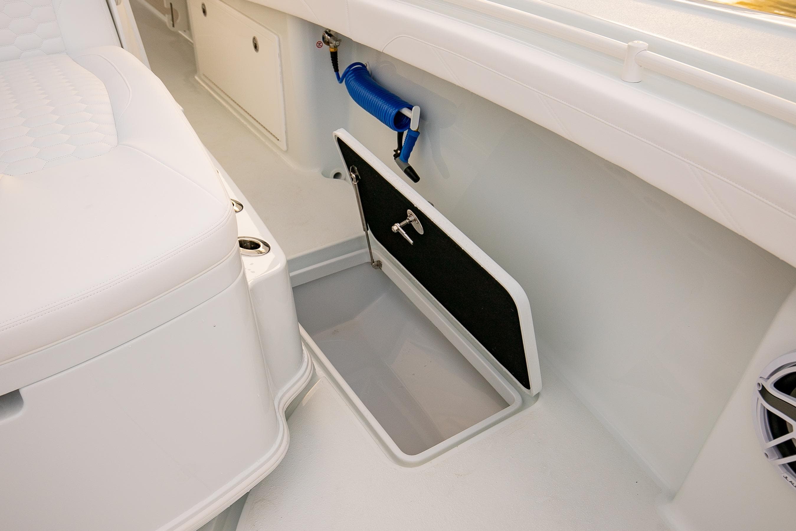 2026 Yellowfin 36 Offshore boat interior with storage compartment and seating.