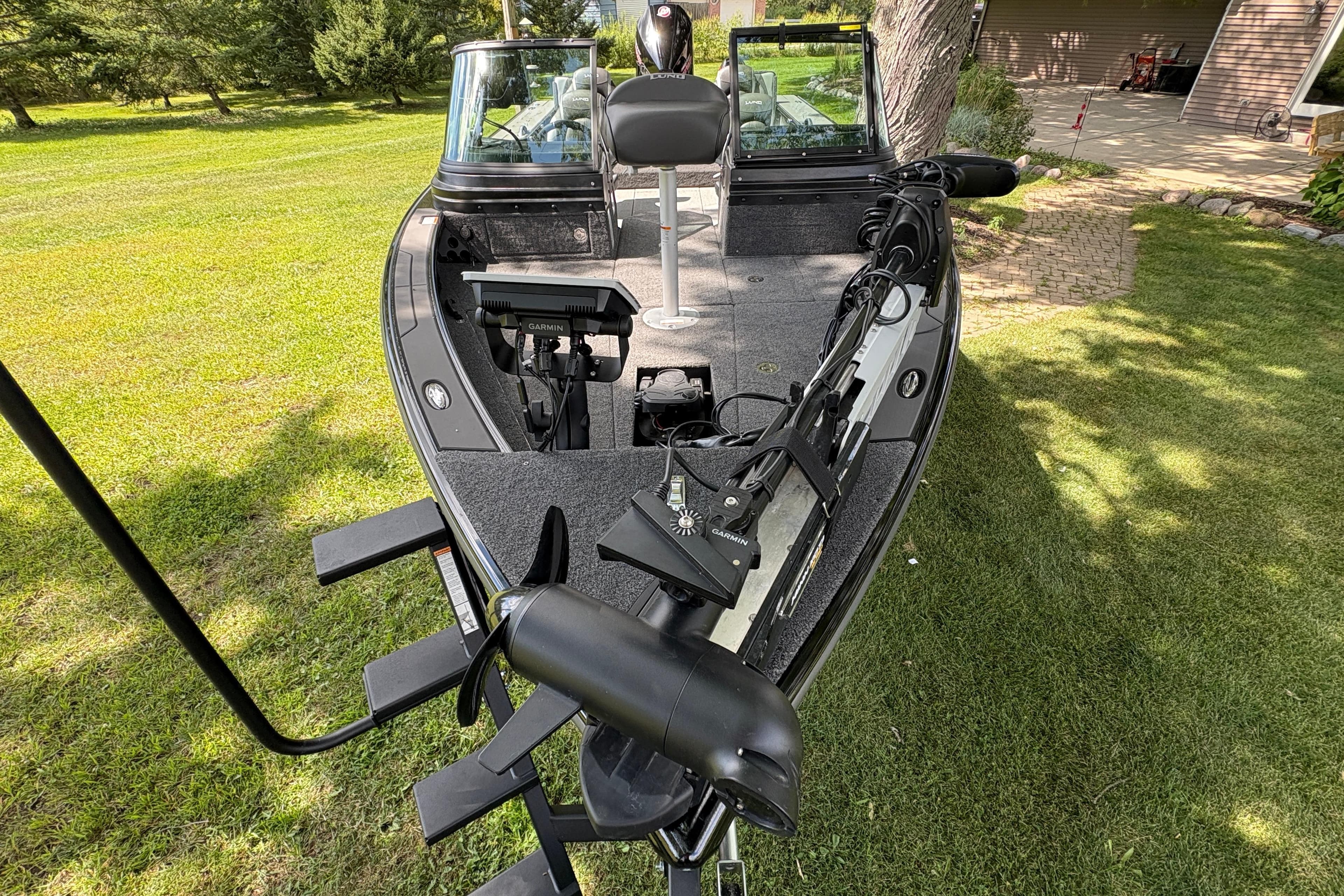 2026 Lund 2075 Pro-V Sport boat on grass, featuring advanced Garmin equipment.