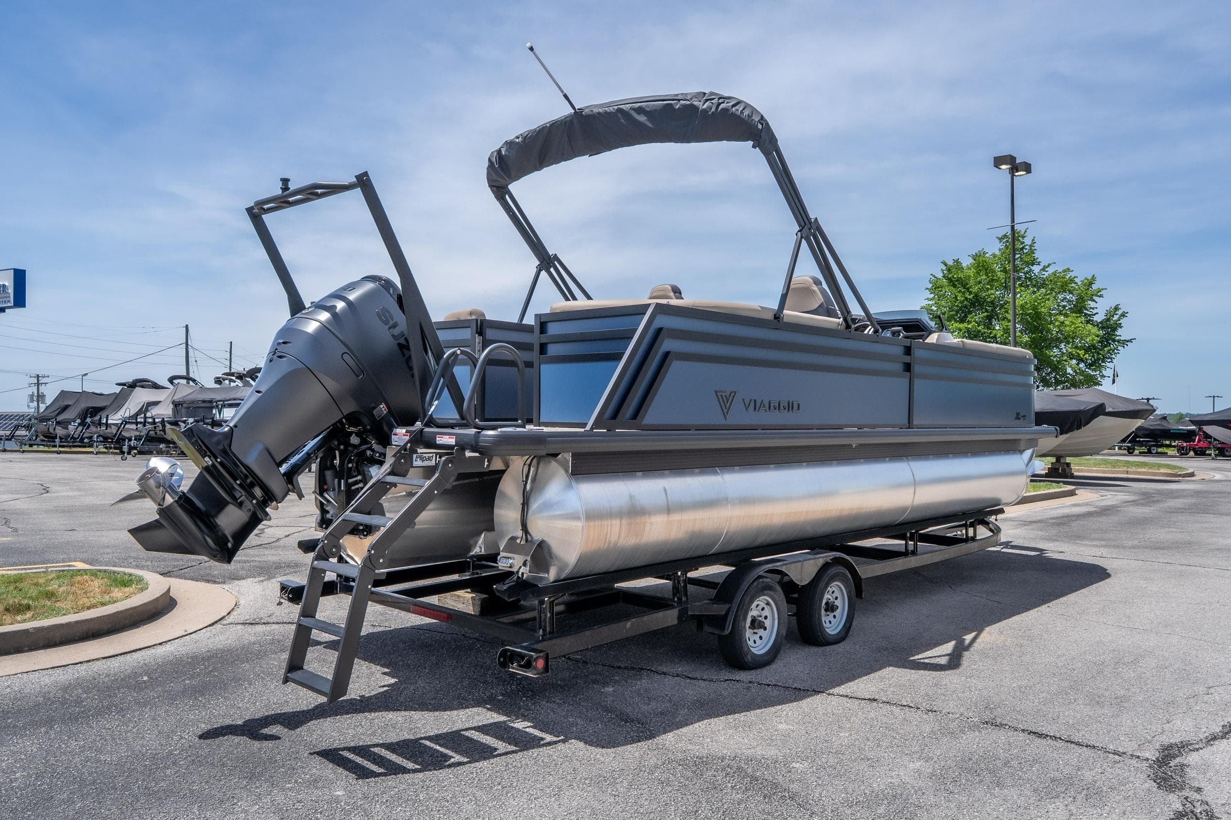 2026 Viaggio X24U pontoon boat on trailer, featuring sleek design and powerful outboard motor.