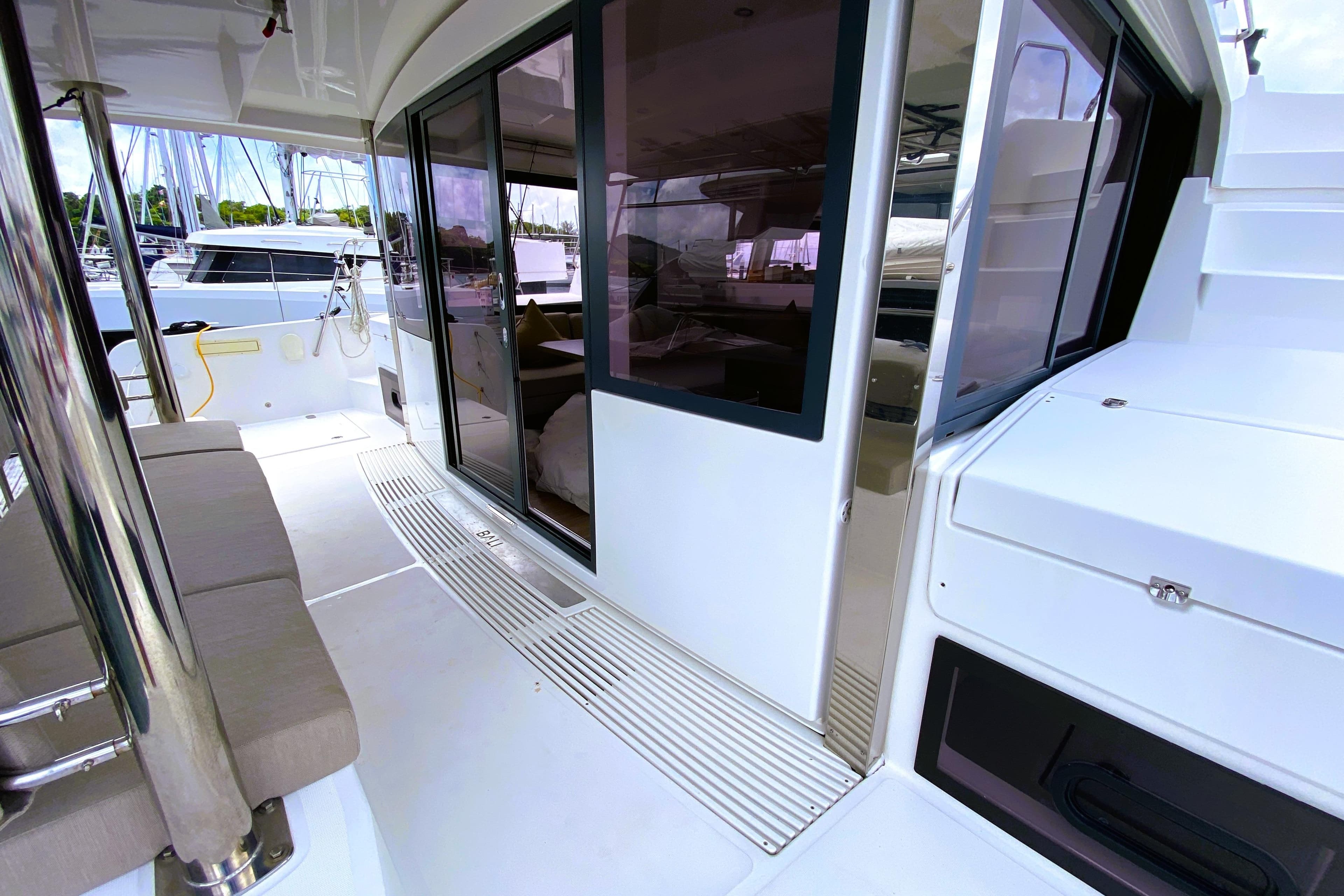 Bali 4.4 Open Space 2022 yacht interior with sliding doors and seating area.