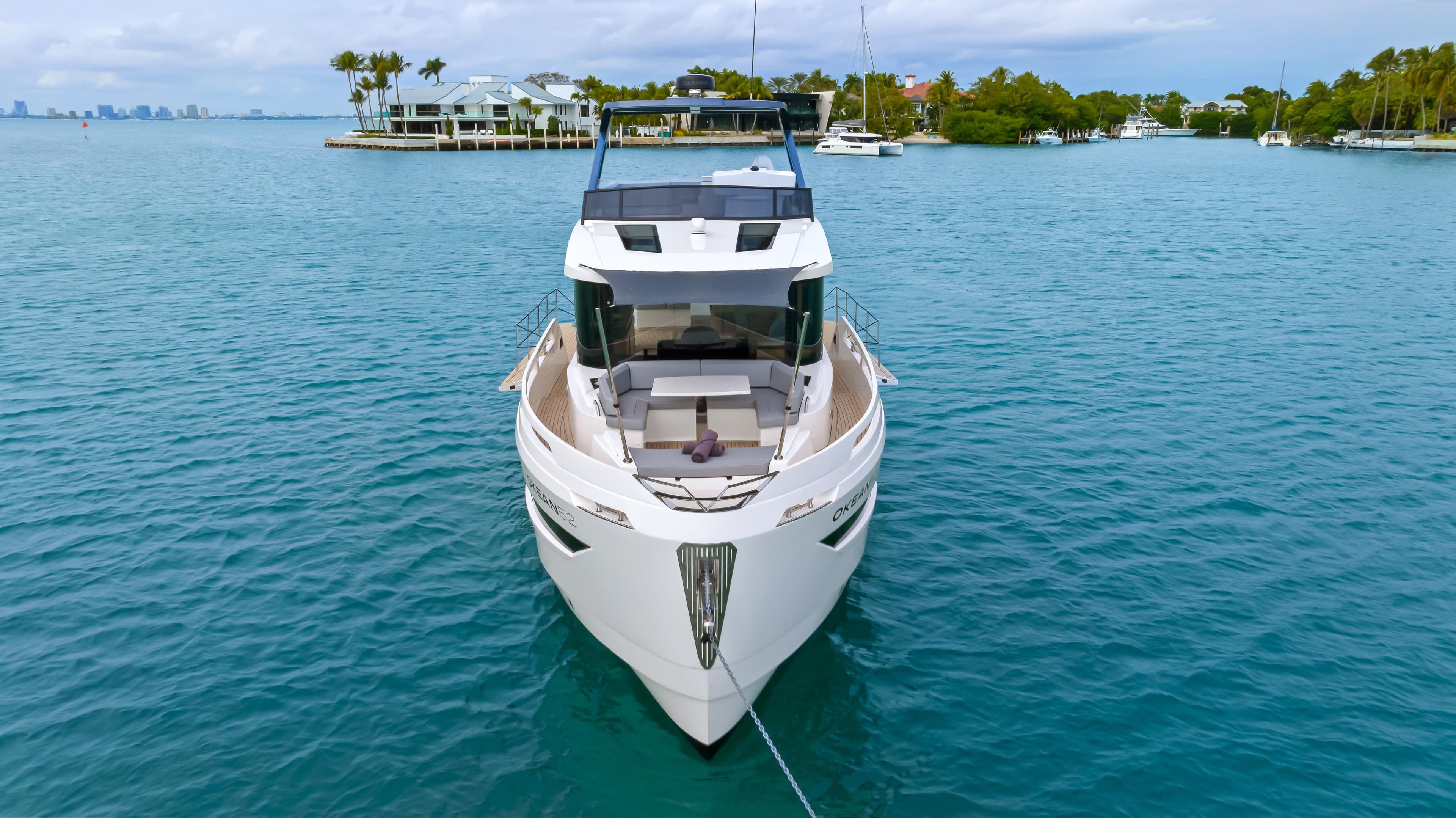 Luxury 2025 OKEAN 52 yacht on serene blue waters.