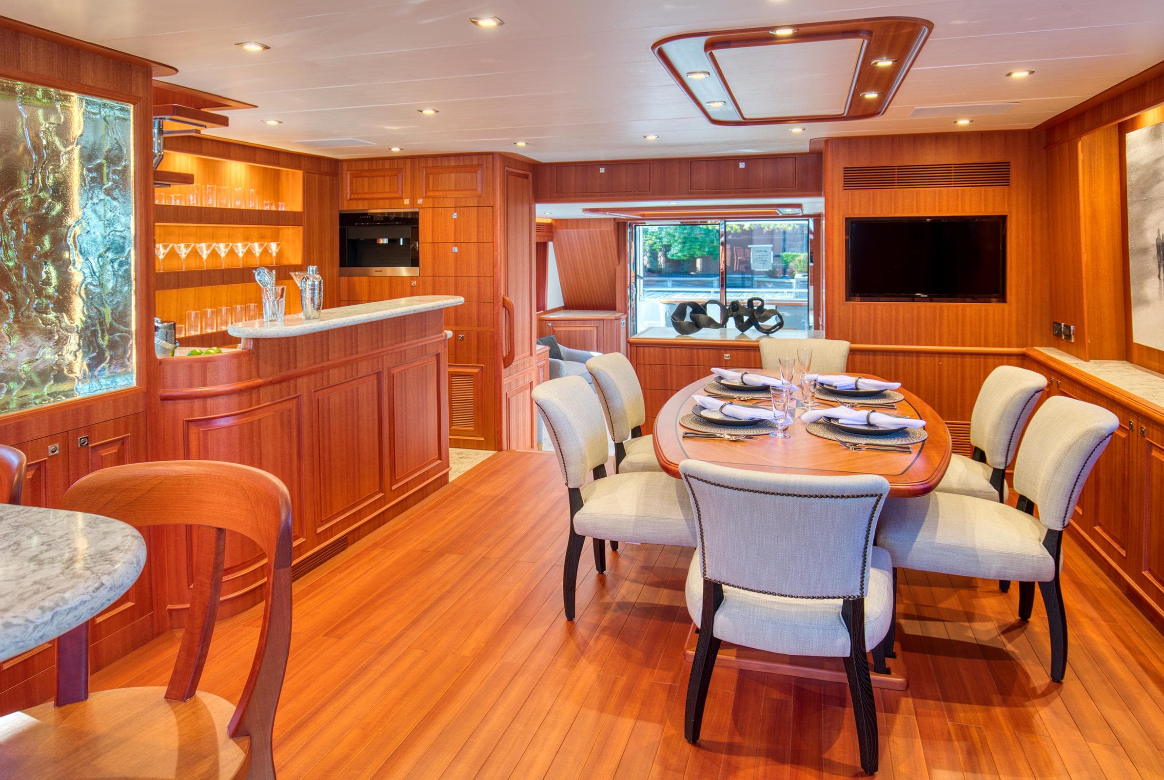 Luxurious interior of 2025 Hampton 750 Endurance LRC yacht with elegant dining area and bar.