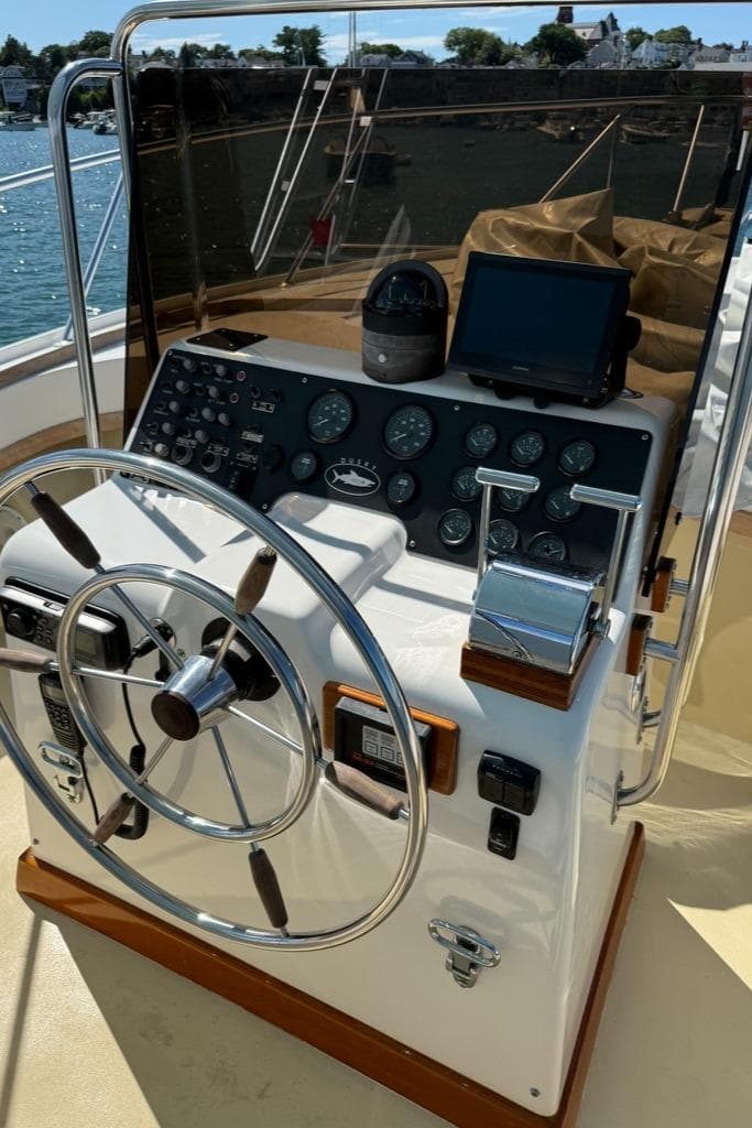 1986 Dusky 26 Custom boat dashboard with steering wheel and navigation instruments.