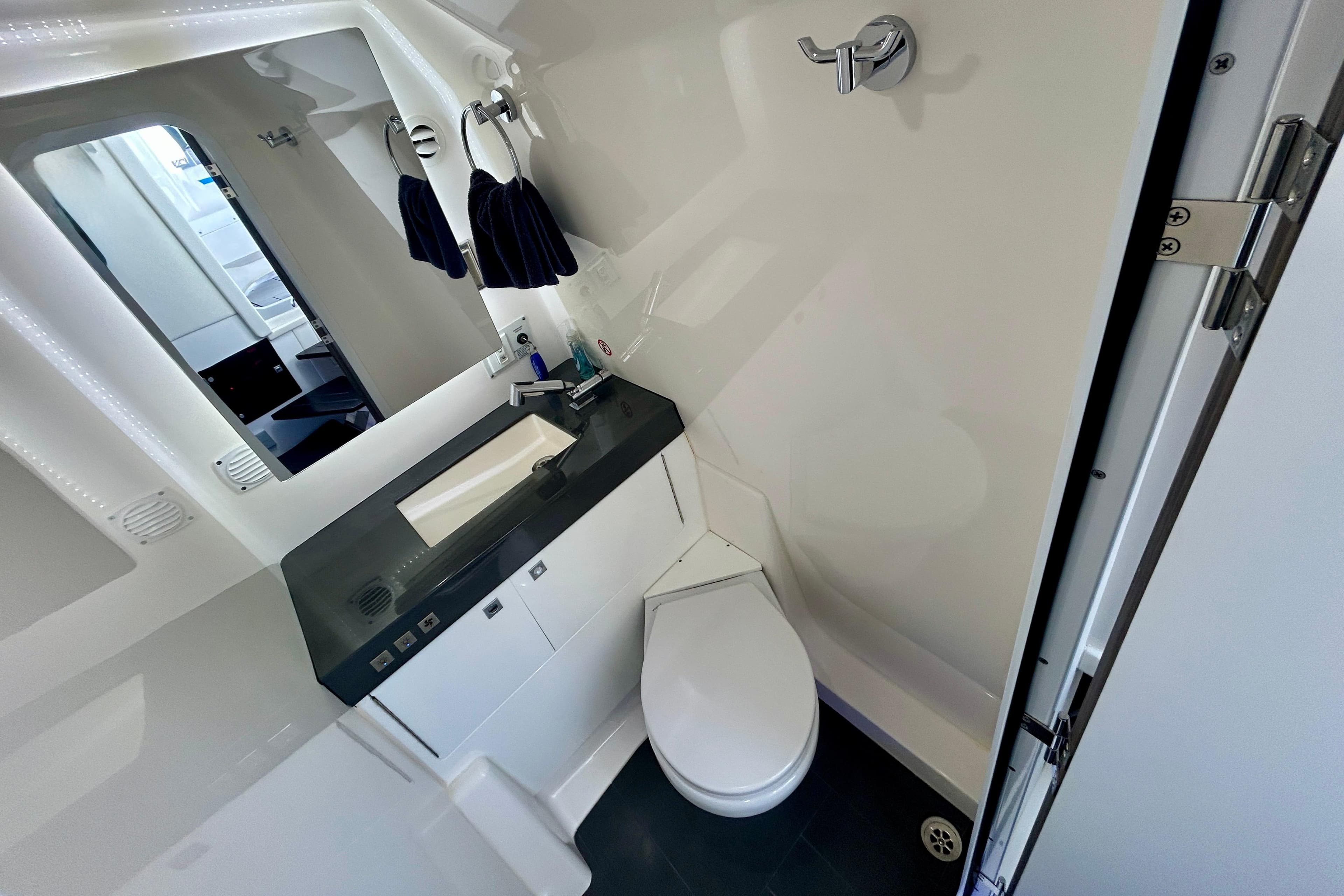 Luxurious 2022 Aviara AV40 OB boat bathroom with modern fixtures and sleek design.