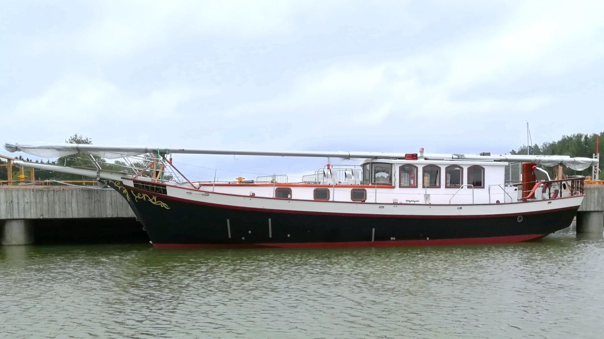 Vintage 1970 Schooner 43 docked on calm water, showcasing classic maritime design.