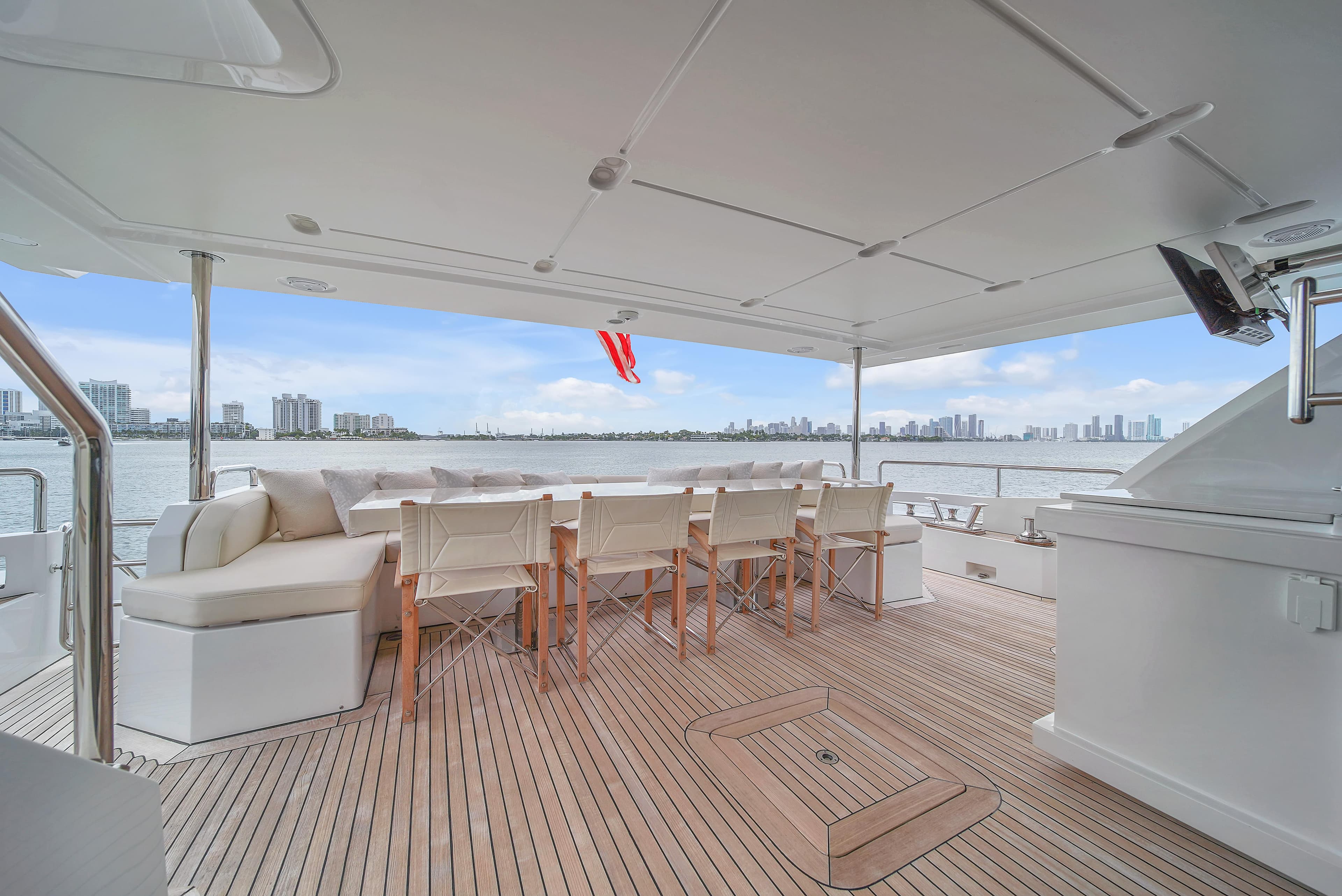 Luxurious 2017 Azimut 95 Raised Pilothouse yacht deck with seating and ocean view.