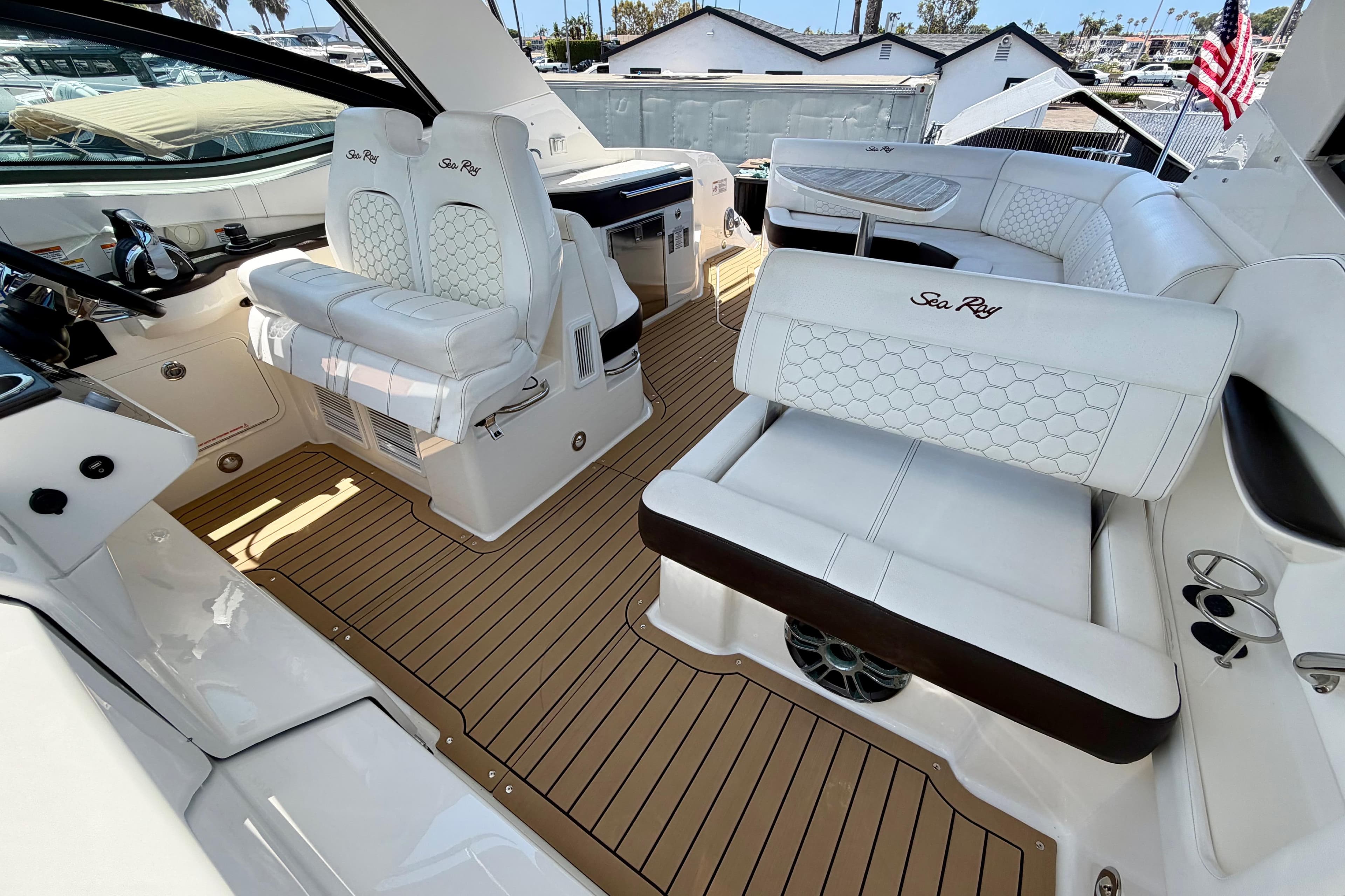 2019 Sea Ray Sundancer 320 interior with luxurious white seating and teak flooring.