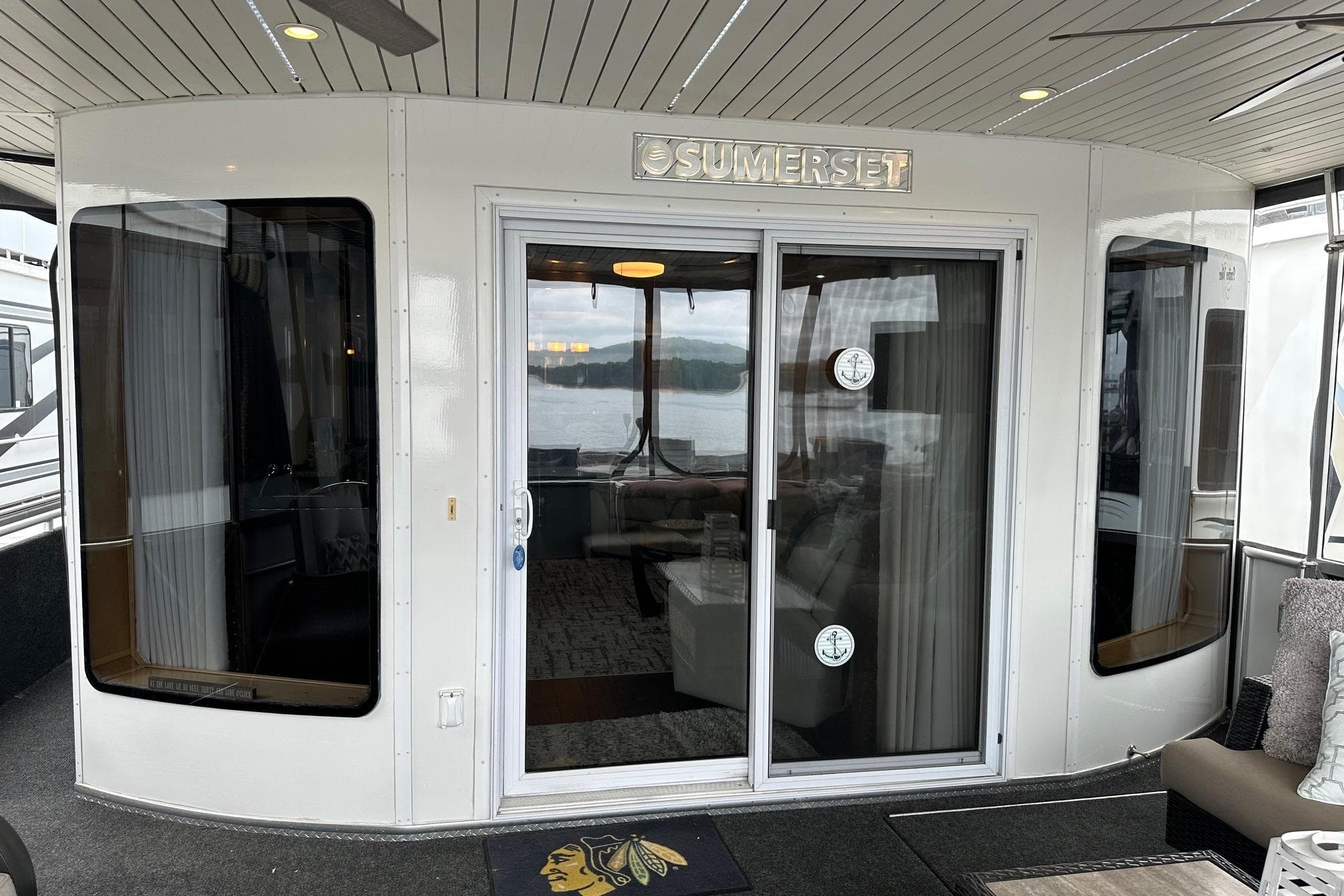 2013 Sumerset 18x85 houseboat with sliding glass doors and lake view.