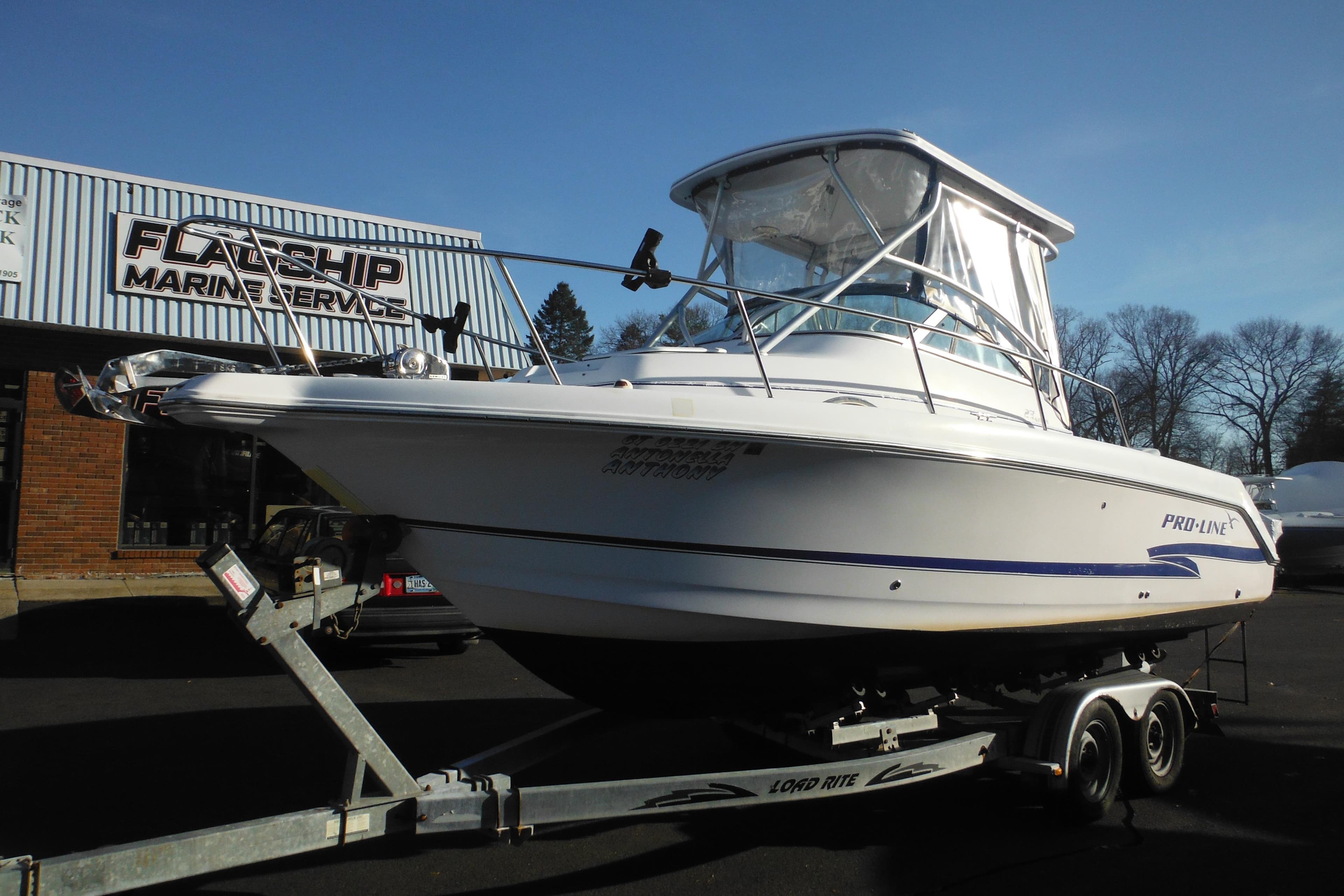 2000 Pro-Line 23 Walkaround boat on trailer at Flagship Marine Service.