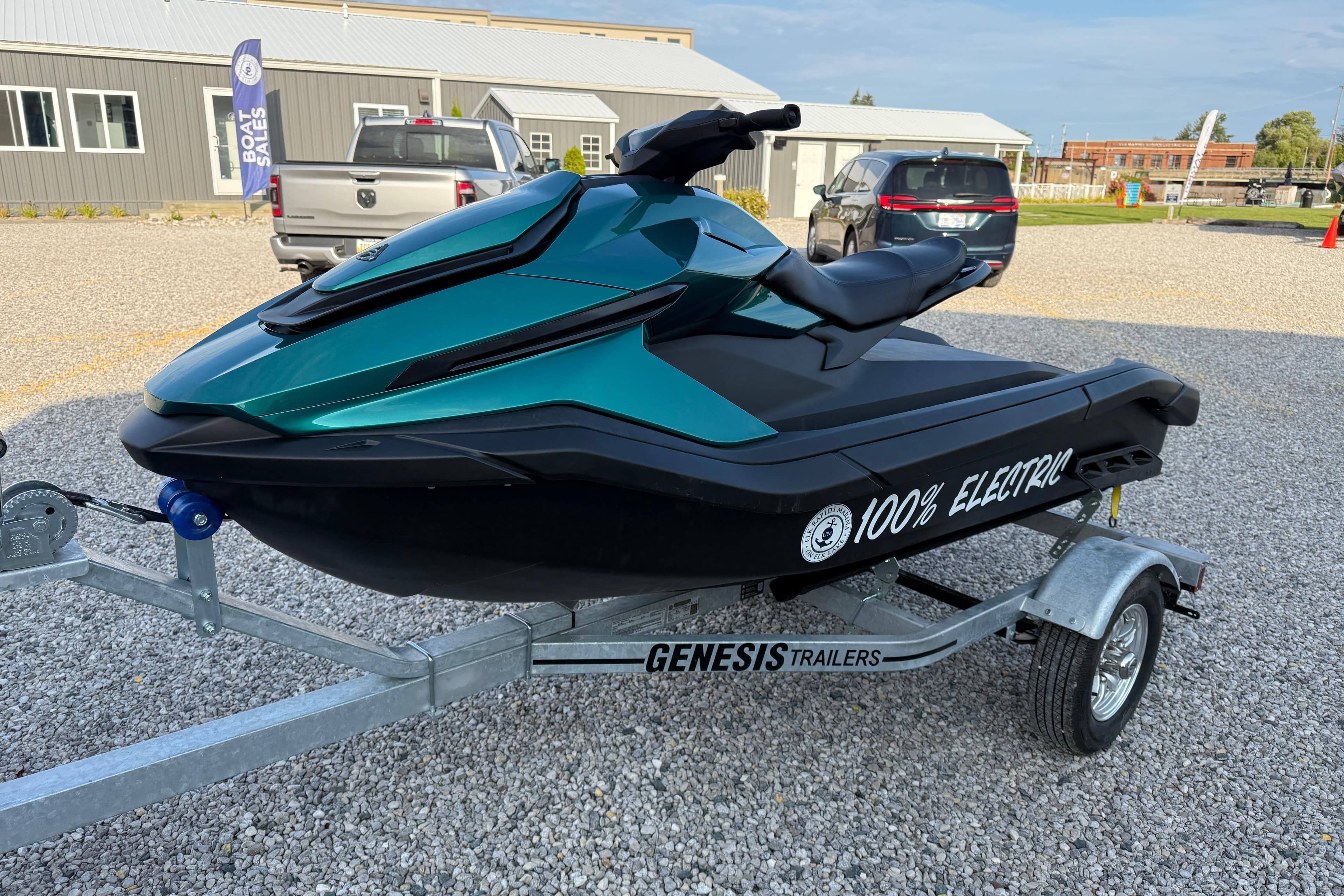 2024 Taiga Orca electric jet ski on Genesis trailer, parked on gravel.