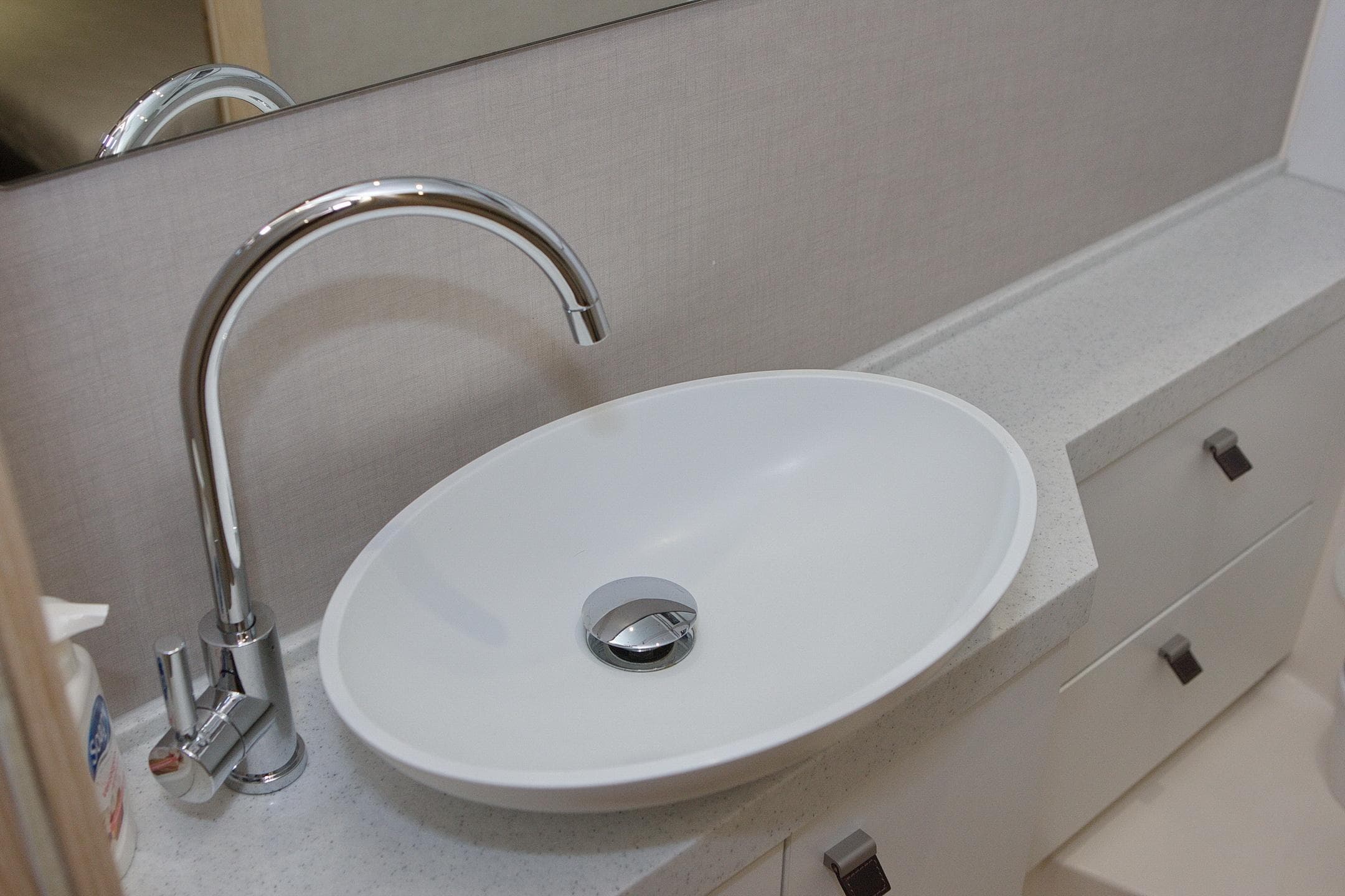 Modern bathroom sink with chrome faucet in 2014 Greenline 48 Fly yacht.