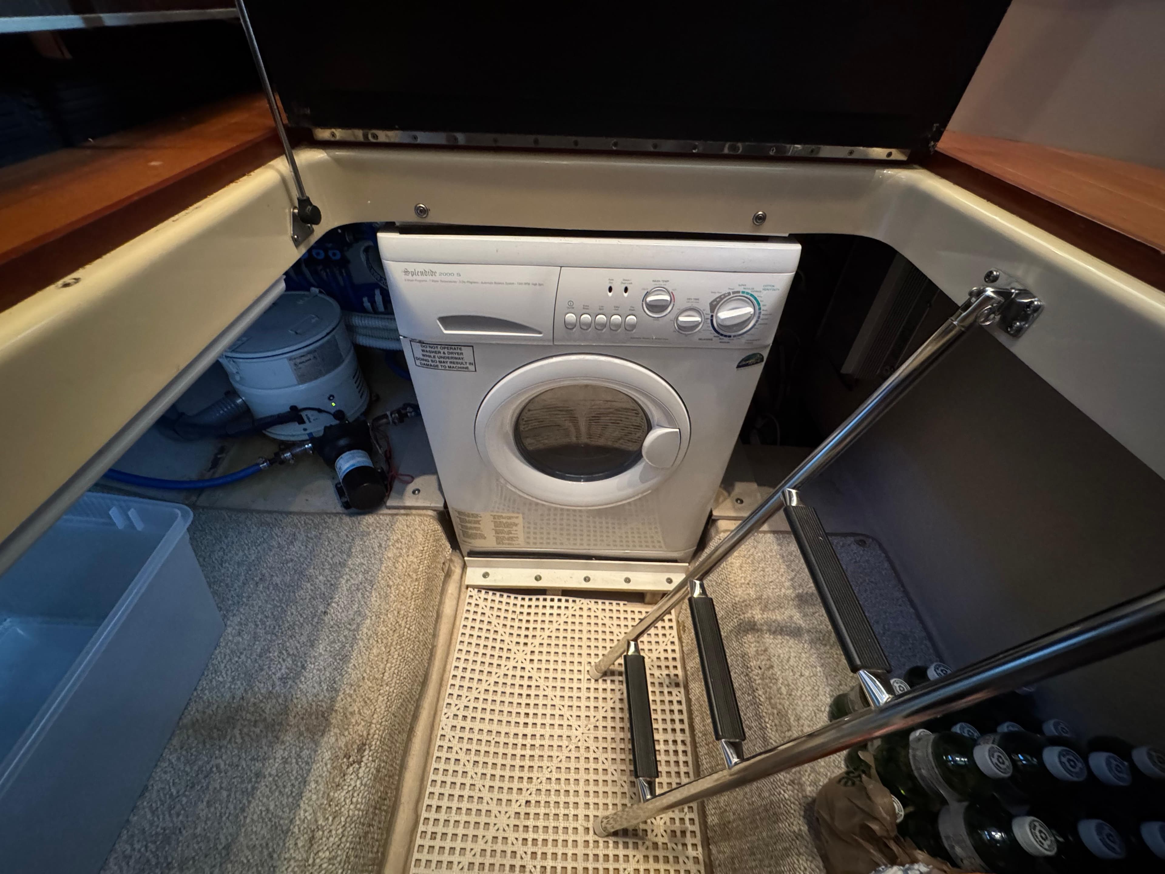Laundry area with washing machine on 2007 Sea Ray 52 Sedan Bridge yacht.