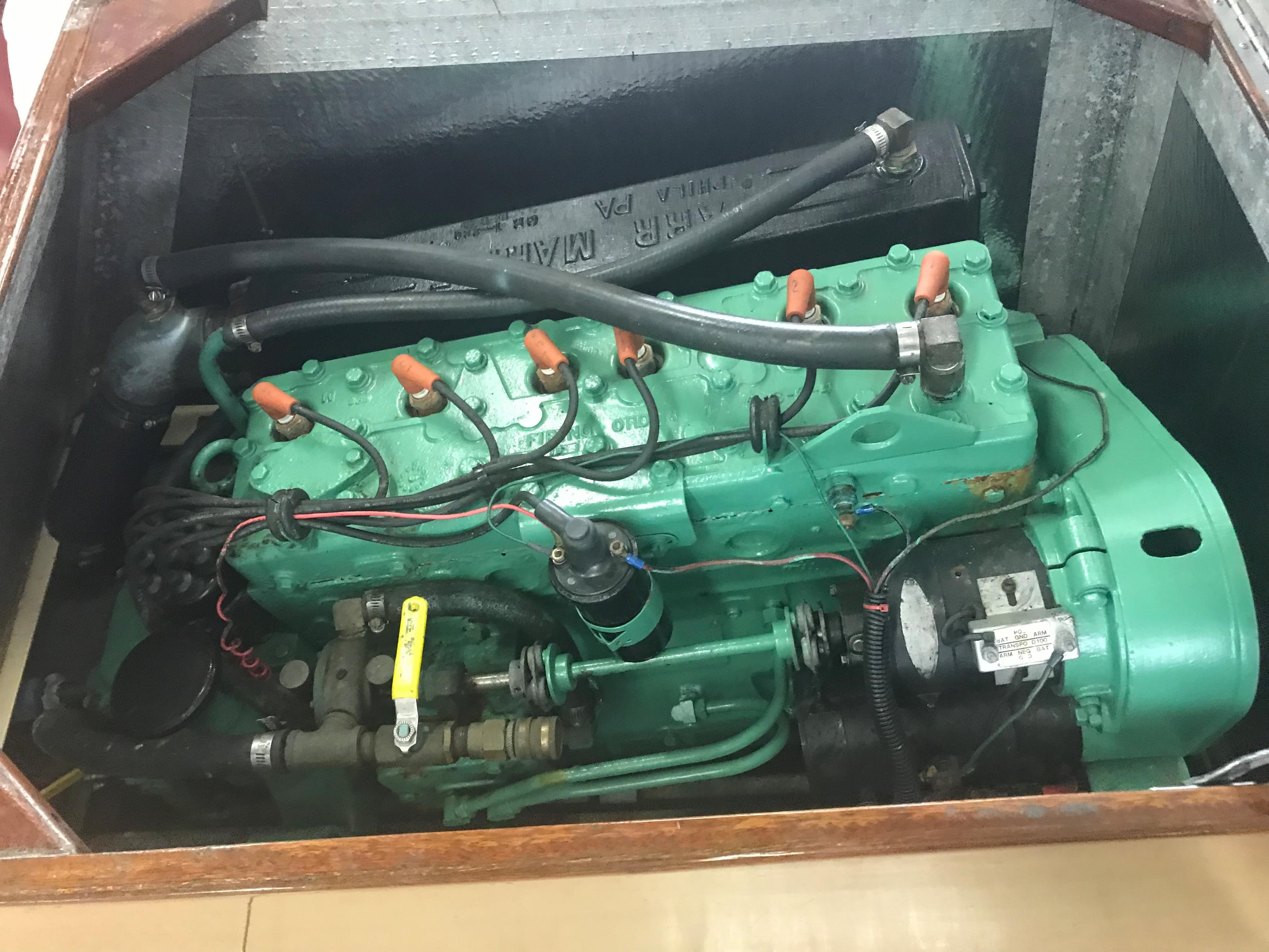 1957 Lyman Islander engine in a wooden compartment.