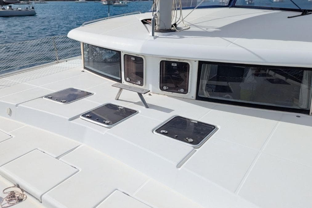 2008 Lagoon 420 catamaran deck with hatches, sailing on calm blue waters.