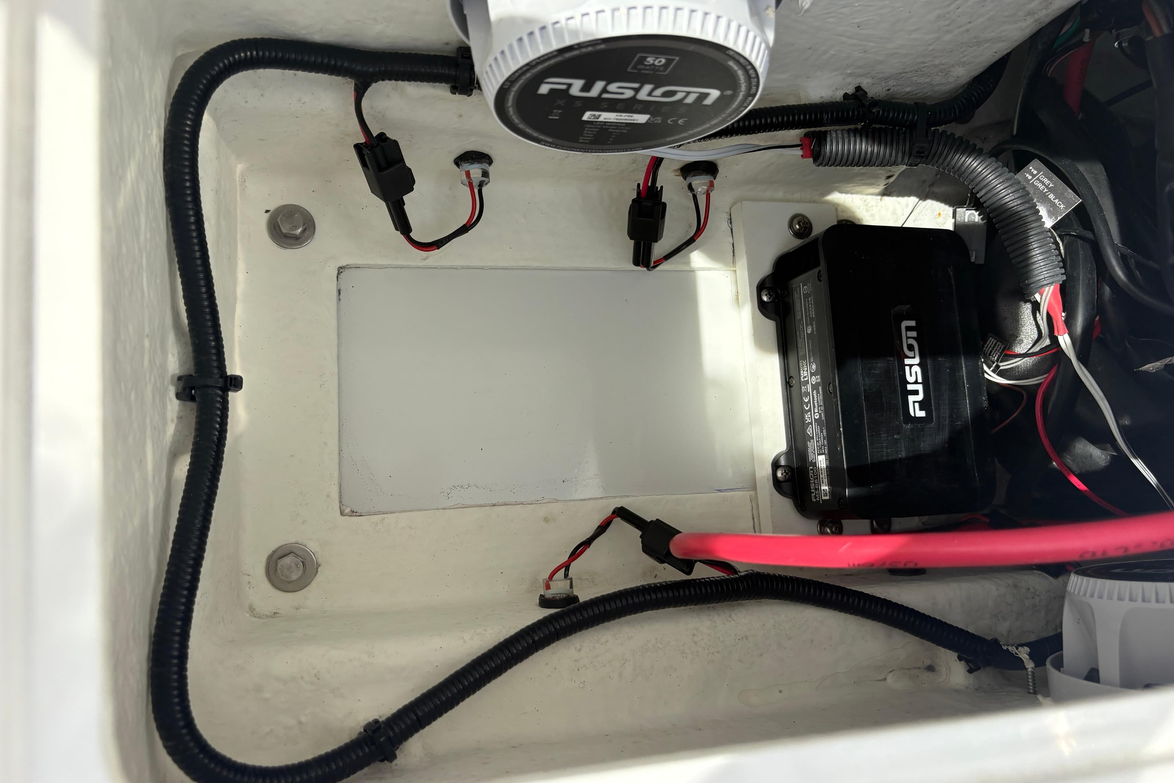 Electrical components inside a 2024 Highfield Sport 360 boat, featuring Fusion equipment.