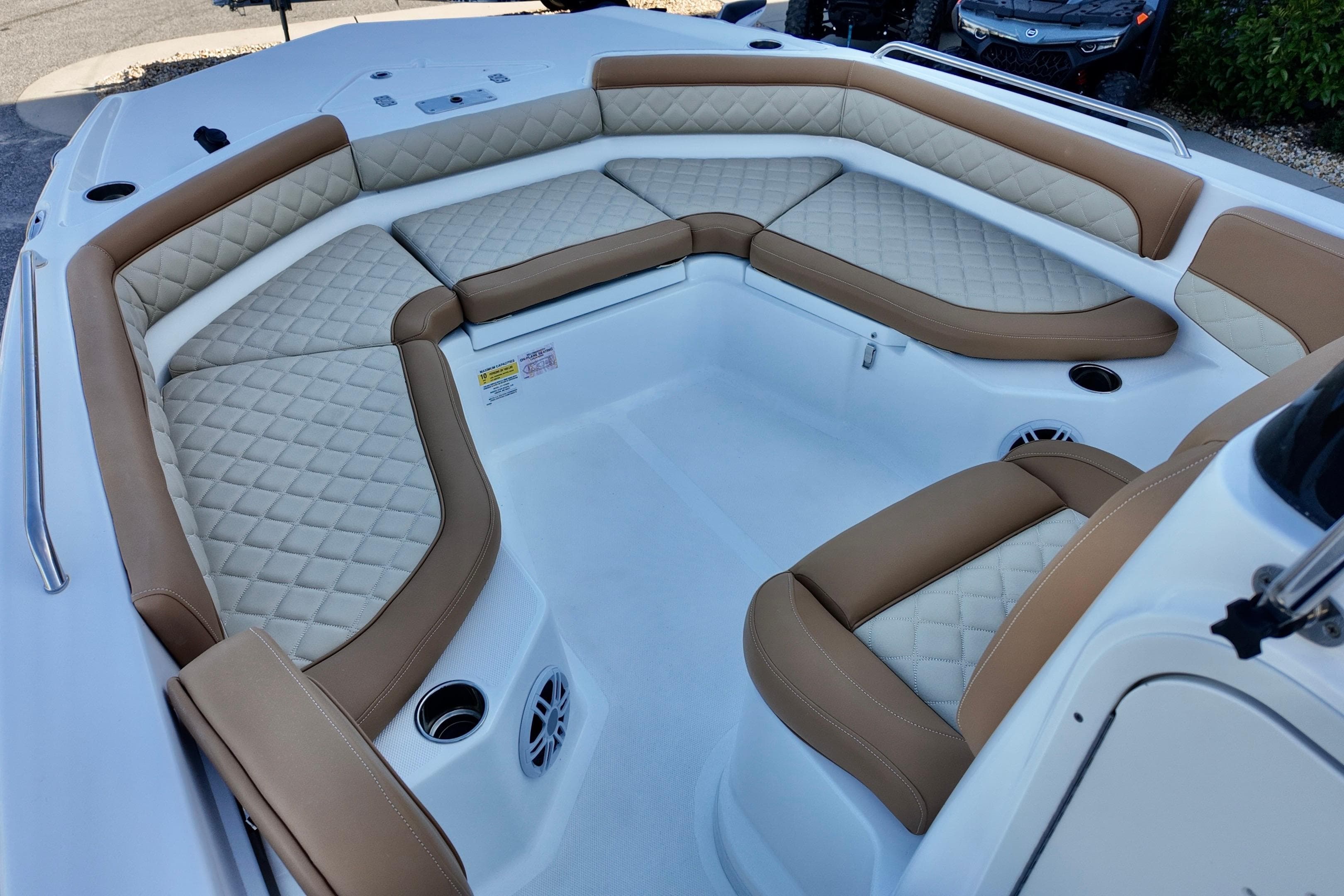 2025 NauticStar 211 Hybrid boat interior with luxurious tan and white seating.